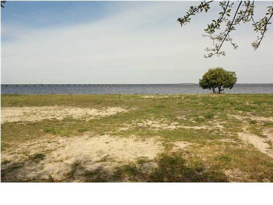 Absolutely gorgeous bay front lot and a fantastic opportunity to purchase in one of Destin's most prestigious gated golf communities and live the Regatta Bay lifestyle! With no build out time you can take your time planing your dream home in desirable Regatta Bay! With the bay as your backyard playground you'll enjoy panoramic bay views! Build your own private boat dock and pier for your water toys! Regatta Bay homeowners enjoy the finest of amenities including first class award winning golf course, beautiful clubhouse with top-ranked Rutherford's 465 restaurant, amenity center with pool, tennis courts and playground, miles of walking and jogging paths, gated security manned entrance. Hop in your golf cart and be at Destin Commons in just minutes and enjoy shopping, dining, Rave