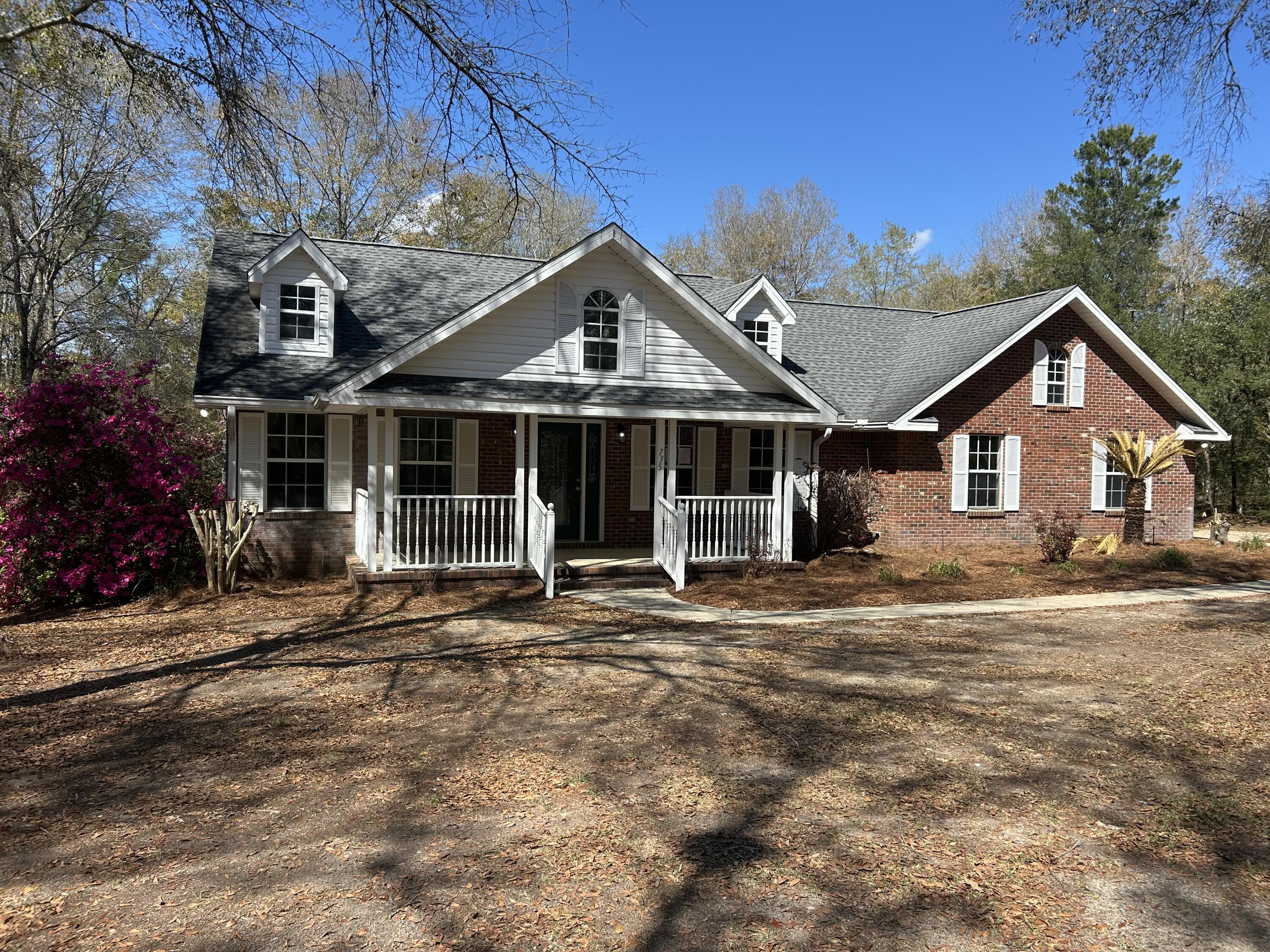 Perfect location in northern Walton County, this Cape Cod design home offers privacy only a short drive to beaches and shopping. Brick home is well built, spacious and charming. Lot offers plenty of elbow room on 5 acres in the country surrounded by oak trees. Home has covered porches on front and back ideal for your porch swing and rockers. Split bedroom floor plan with extra-large master bedroom and huge walk-in closet. Recent updates include LVP flooring, quartz kitchen countertops, interior walls & ceilings painted throughout, new garage door, bath vanities, and new light fixtures throughout. Azaleas of many colors surround the home and a grape arbor out back. Detached utility shed with concrete floor has garage door. Could be used as workshop or car parking. Call for showing!