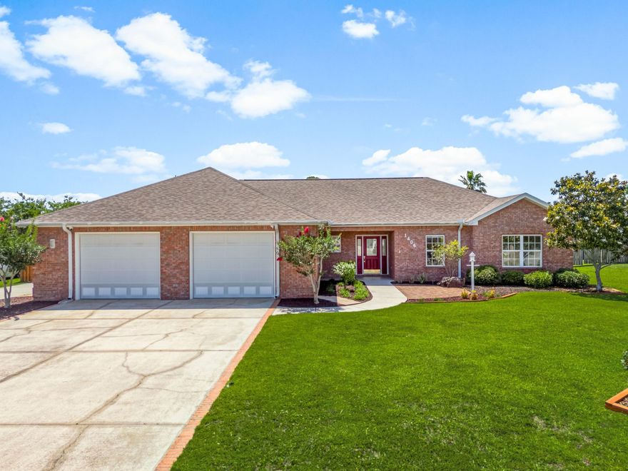 At the quiet end of a cul-de-sac in one of Lynn Haven's most established neighborhoods, this beautifully maintained four-bedroom, three-bath home offers timeless comfort and thoughtfully designed spaces for everyday living. Set on a generous 100' x 150' lot in a golf-cart-friendly area with no HOA, the property is ideal for families, retirees, or anyone seeking a relaxed lifestyle near top-rated schools and daily conveniences.Built in 2002, the home spans 2,216 square feet and showcases a traditional brick facade, complemented by a split floor plan that includes two private en suite bedrooms.  A tiled foyer with coat closet leads into a welcoming living area with 11-foot tray ceilings, crown molding, and a natural gas fireplacean ideal setting for both quiet evenings and festive gatherings. The kitchen features maple-finish cabinetry and a functional layout for cooking and conversation. It connects to a formal dining room with recessed lighting and access to the screened patioupdated in 2021 with new screens and doors. This serene space opens to a fully fenced, landscaped backyardperfect for children, pets, or unwinding with coffee in the morning light.

The spacious primary suite includes a large walk-in closet and a private bath with dual vanities, a whirlpool tub, a separate shower, and built-in storage. Secondary bedrooms are equally well-appointed, with ceiling fans and generous closets. A second ensuite offers flexible accommodations for guests or multi-generational living.

Additional highlights include a 2024 high-efficiency four-ton, 18-SEER HVAC system with new ductwork and smart thermostat, a hybrid electric water heater (2015), and a 2018 architectural shingle roof. The oversized two-car garage provides more than 780 square feet for vehicles, storage, or a workshop setup. A dedicated irrigation system, city services, and extended driveways complete the picture of ease and convenience. 1406 New Jersey Avenue is a refined retreat offering lasting quality, valuable upgrades, and a sought-after address in the heart of Lynn Haven.
