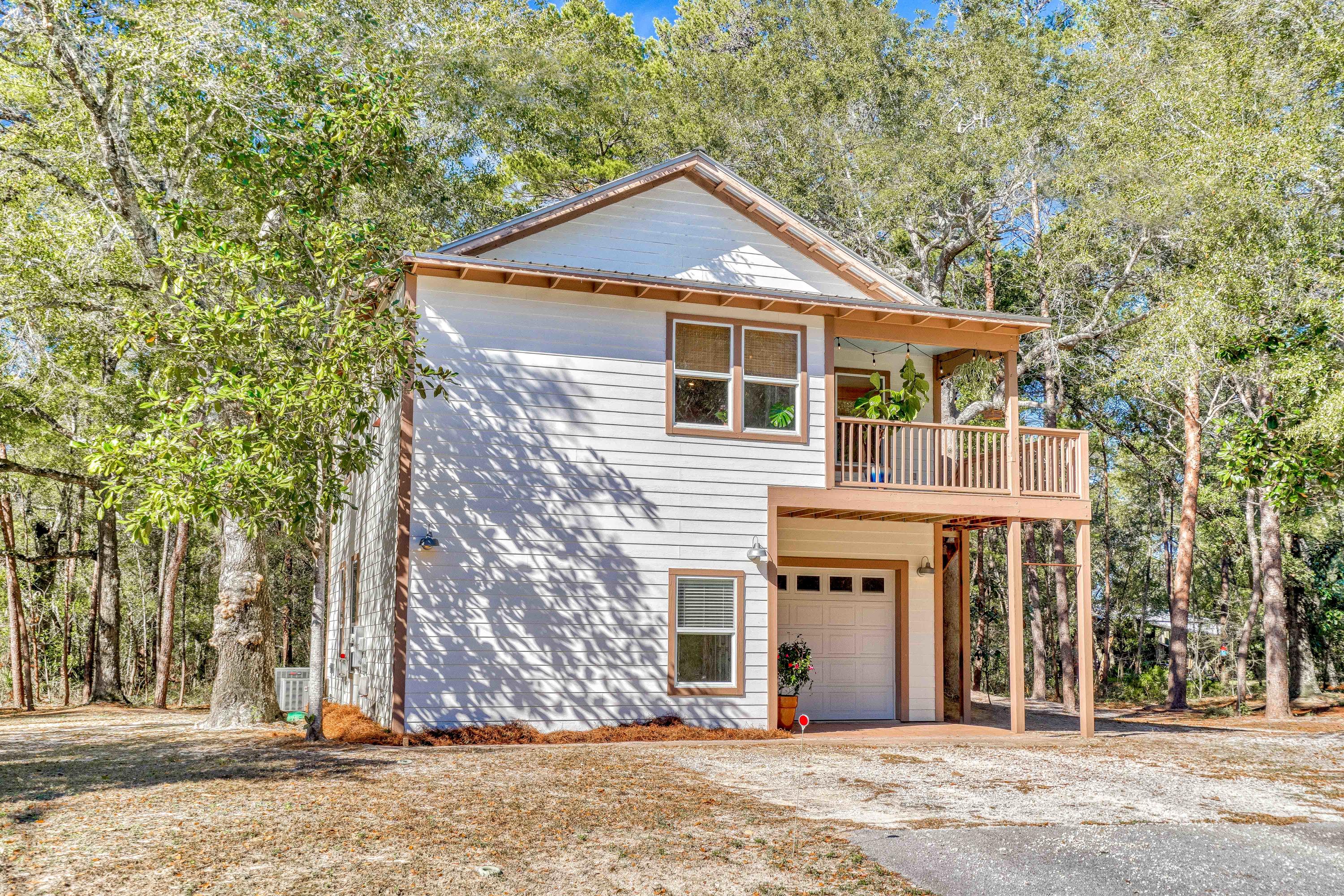 Just 5 minutes to Grayton Beach or 3 minutes to the Choctawhatchee Bay...Situated in the heart of Point Washington, this quarter acre property offers a 1,500sqft carriage house with 2 bedrooms, 2 baths and land to add a another structure. Upon entering the home you will proceed upstairs to the main level providing an open concept design with living, dining, & kitchen areas. A sizable bedroom, with spacious walk-in closet and washer/dryer hookup, as well as a full bathroom are also found on this floor. The first level contains the master suite, a small bonus room and an additional washer/dryer hookup. The bonus area presents several options including expanding the master closet to a generous walk-in, a sitting room, or even an office. If you were to keep the bonus room as its current use; a mudroom, there is a doorway available that can be opened up from the garage directly into this room, making the garage accessible from inside the home. A single car garage designed to be heated & cooled if desired finishes off this home. The a/c system is already in place and would only require finishing with duct work & a vent. Lastly, if your preference is to keep the ground level a private master suite, a stairway is available on the exterior with direct access to the main living area. This is truly a unique property surrounded by beautiful hardwood trees, and adjacent to the Point Washington State Forest.