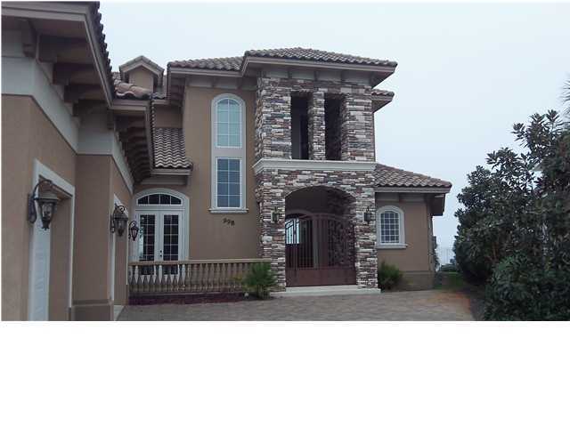 This spectacular home in the gated community of Emerald Bay offers every upgrade imaginable. The formal living room overlooks the pool and bay with large open windows. Gorgeous and expansive bay views are offered from every room in the home, including the gourmet kitchen features granite counters, tons of counter space including a center island, and stainless steel appliances. The master suite on the ground floor offers bay and pool views,ceiling with recessed lighting, large master bath with granite counters and dual vanity, and a large garden tub and separate tile shower. The downstairs also offers a perfect home office. A beautiful hardwood staircase leads you to the second floor, which features three additional bedrooms, media room, and a huge balcony thatis acce