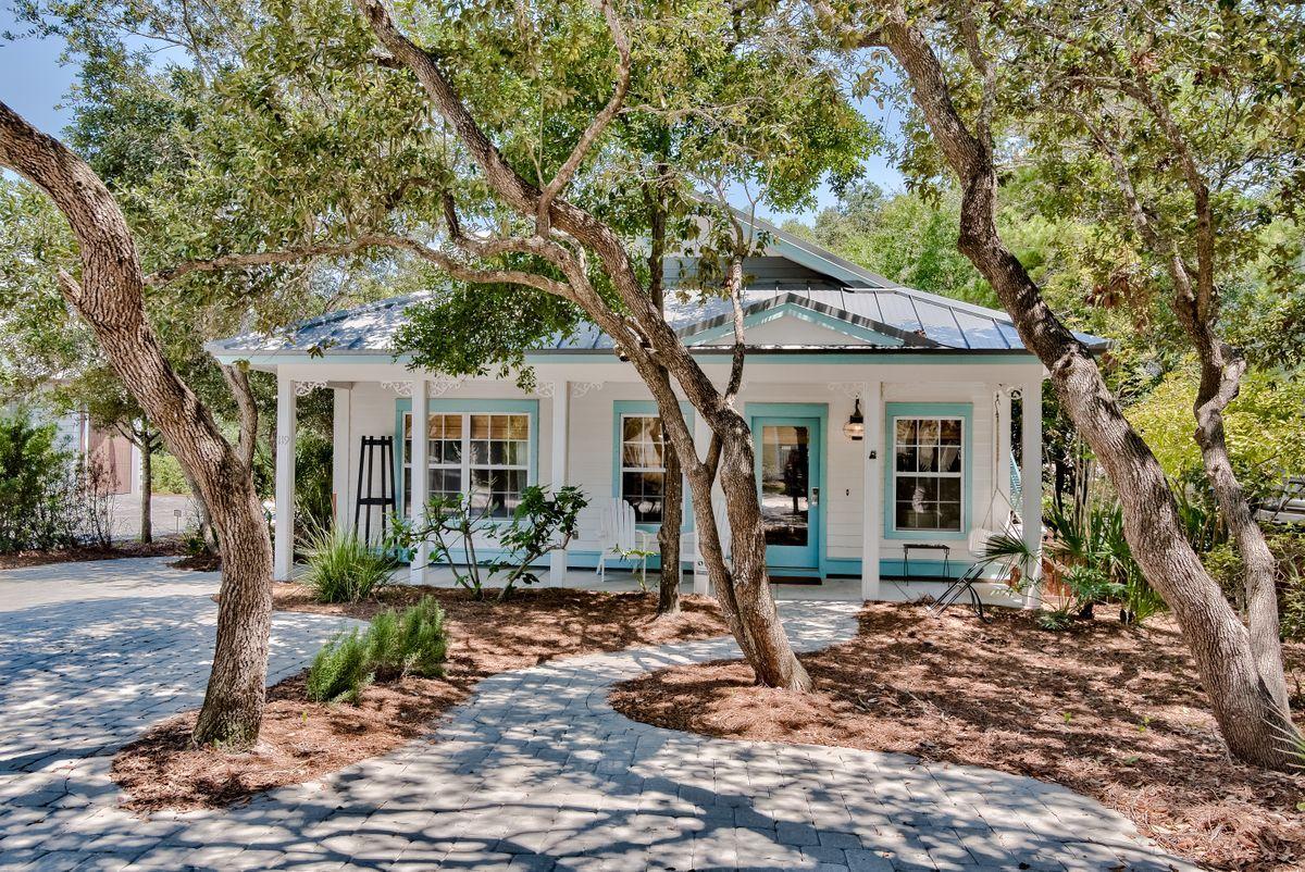 Ideal location and quintessential Old Seagrove lifestyle converge at 119 East Grove Avenue, a gorgeous five bedroom cottage that is perfectly positioned one block from the beach and less than a mile from Seaside. This home features a new rooftop viewing deck with gulf views as well as an independent attached one bedroom, on full bath lockout suite complete with a kitchenette and outdoor balcony. The interior of this home is complimented by finely appointed accents such as hardwood flooring throughout, stainless steel appliances and a spacious open floor plan. The home also boasts an oversized screened in porch with ample privacy surrounded by a fence and stunning natural foliage.