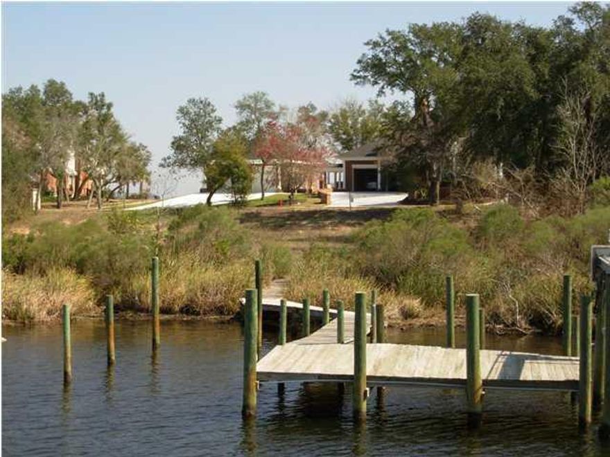 Motivated Seller! One of very few remaining available lots in the gated community of Shalimar Pointe. This waterfront lot represents an incredible opportunity to own and build your home on over 1/2 acre lot with permitted dock already in place. Protected waterfront with bay access within 300 yards- best of both worlds!Don't let the days on market fool you. It has been overlooked prior out of fear of the unknown- fear no more! Seller now has available for buyer inspection a geo-technical survey and new boundary survey. These two documents in the hands of a builder will allow one to not only see the ease of construction but the possibilities of capitalizing on its sloping grade. Ideal build could have a side entry garage below on the walk-out level and circle drive in the front. Built on this sloping lot a home could have an amazing rear patio on the main level providing incredible water views and unforgettable sunsets! Should there be an upper level it would have the same incredible rear view and front views towards Destin across the bay- enjoy amazing sunrises!  

The lot also already has the sewer tap fee paid and a dock- saving thousands and countless hours of work for the new owner. 

Call your agent, call your builder- don't let this one slip you by.