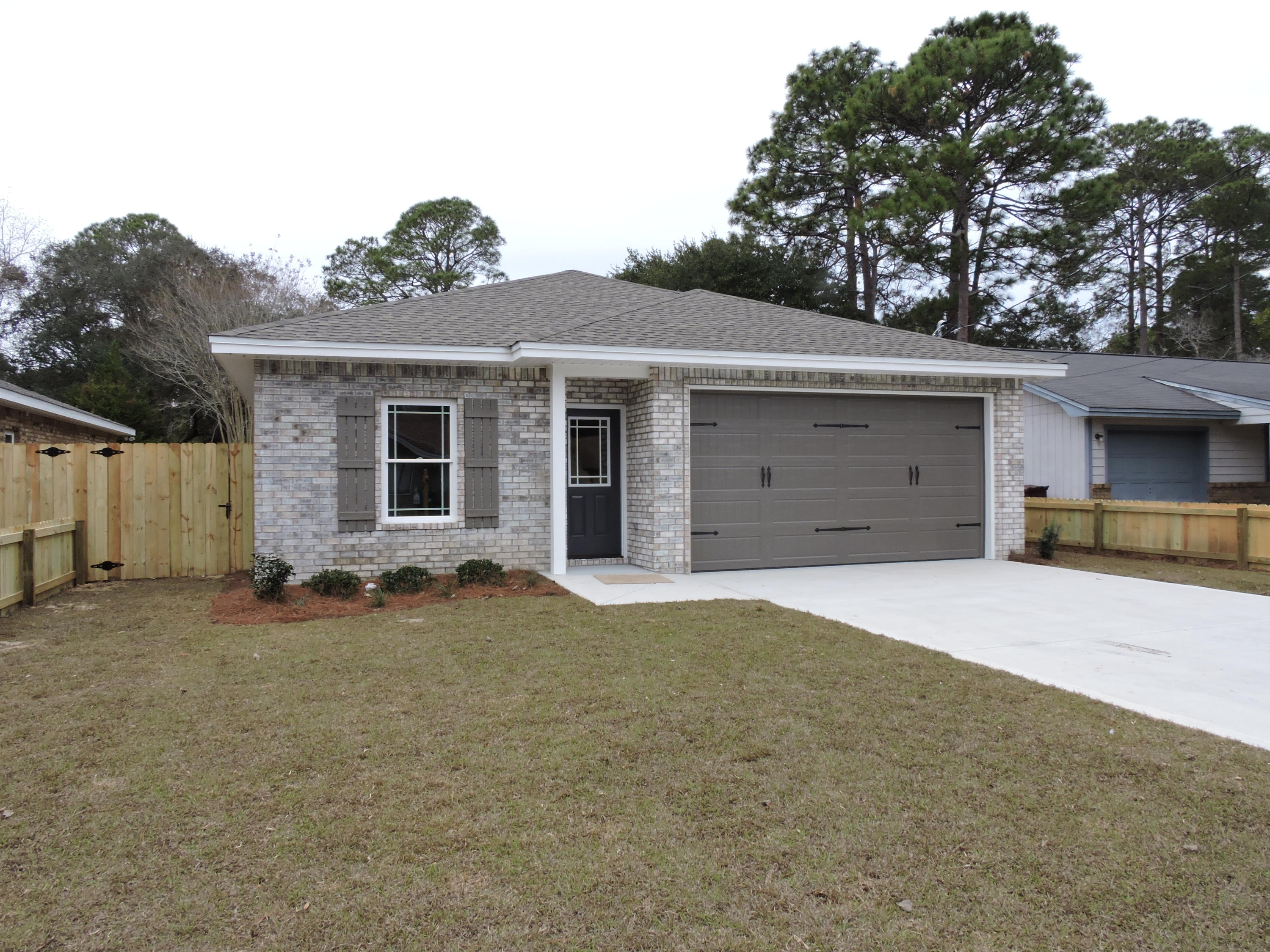 READY TO MOVE IN. Absolutely beautiful all brick NEW home built by one of our great local builders. Central location just minutes from Eglin AFB, Duke/SF, the beaches, shopping, and all the fantastic Niceville Schools! Large open floor plan has a gorgeous kitchen with a center island. The kitchen has stylish lighting, granite counters, and quality cabinets with soft close doors. HUGE PANTRY! Vinyl flooring and carpet throughout. Large master suite with a walk-in closet, double vanities, and a spacious shower. 2 more nice bedrooms and another beautiful bath. 2-car garage has peg board already installed to help organize and keep everything tidy. Back yard is a great size, plenty of room for the kids or dog to play, and is fully fenced.