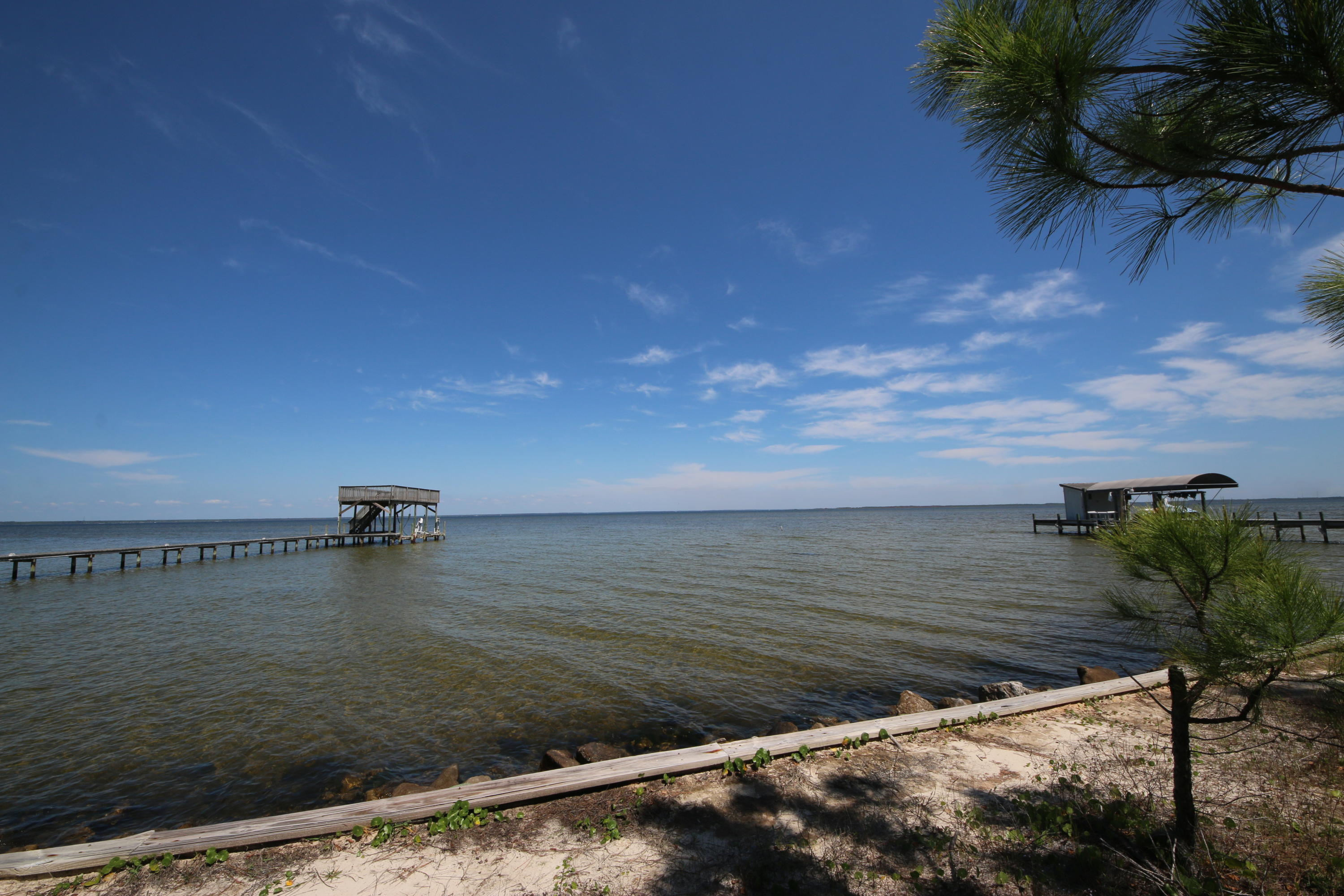 Spacious lot in the exclusive gated community of Grand Cove within Driftwood Estates. There are very few lots left in Grand Cove and this is an amazing value for a waterfront lot next to breathtaking homes. This beautiful lot has 113 feet of water frontage offering endless views of Choctawhatchee Bay, which is accessible to the emerald waters of the Gulf of Mexico. A seawall is already in place. Build your perfect dream home with incredible Bay views. Only minutes from the golf, restaurants, and shopping of Sandestin Resort & Baytowne Wharf. Also enjoy the convenience of Grand Boulevard Town Center around the corner and the Gulf of Mexico and white sandy beaches just a short drive. This is one of the few lots that is not part of Greater Driftwood HOA so there is no capital contribution!
