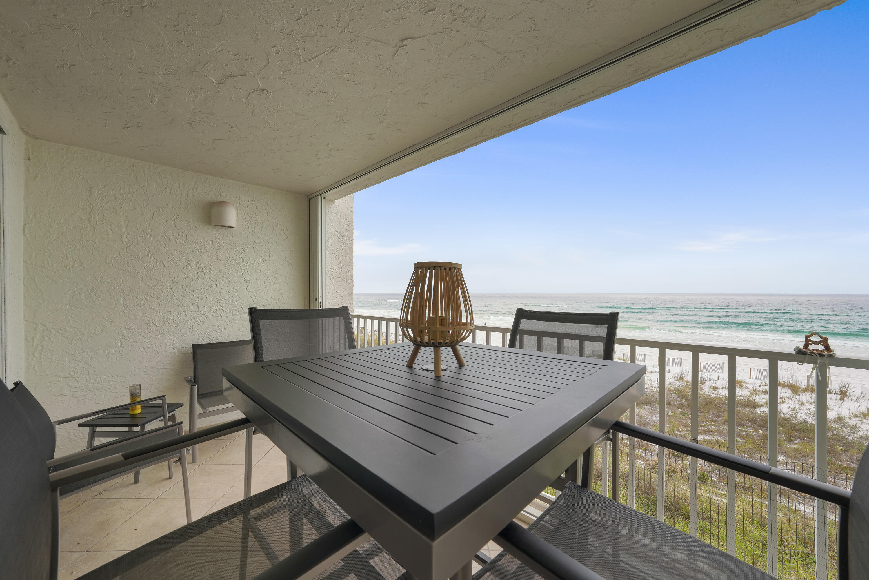 Phenomenal Gulf and white sand beach views from this turnkey 3rd floor unit! Great off season opportunity and competitively priced!Tiled floors throughout, stainless steel appliances, granite countertops, white cabinets, comfortable and elegant furniture and decor included. Hurricane shutters. The Grand Mariner is a gated building with on-site management office. Amenities include community room, pool side fitness center, heated pool, 375ft of private beach, and elevators.