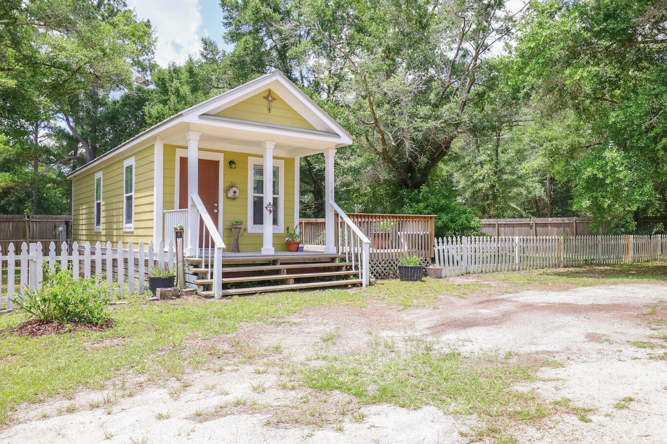 Tiny Home! Adorable Florida Cottage with a large open deck wrapping around the front and down the length of the home. Featuring crown mounding, granite countertops, built-in dresser, and tile throughout. Built strong to withstand 165 mph winds, with double-pane windows, metal roof, Hardie board siding, extra insulation for energy efficiency, and 2 mini-split a/c units to keep you cool. The home has been part of a rental portfolio generating approx $1400/monthly. Enjoy a larger yard (approx 1/4 acre), or build on the adjoining lot, all tap fees are paid!