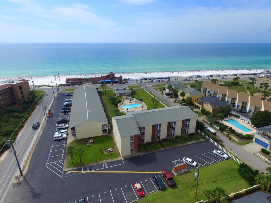 1st Floor Corner Condo in Great Location across the street from the Beach. Located on Scenic Gulf Dr, across from Pompano Joe's Restaurant & Miramar Public Beach Access. Low density complex of 32 units has a Community Pool with bathrooms, large green space, BBQ & picnic area & onsite management. 2 bedroom/ 2 bath Condo comes fully furnished & is rental ready. New Ceramic Tile Floors throughout, new Kitchen Cabinets & Countertops & new HVAC installed in 2013. Master Bedroom has King Bed & ensuite bath with stackable Washer & Dryer. Guest Bedroom has Queen Bed & Bunk Beds. Living Room has a pullout Queen Sofa Bed. Dining Room table seats six with extra space at the breakfast bar. Covered Patio for Dining & Enjoying the Views. Also an Outside Storage Area. Relax & enjoy a Great Beach Condo.