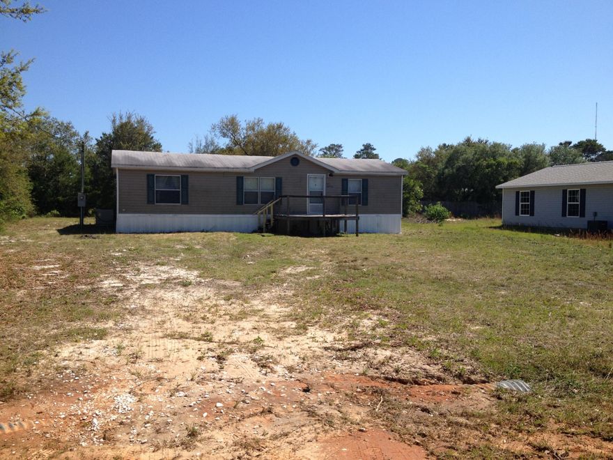 PRICE REDUCED. SELLER SAYS BRING AN OFFER! East Bay Heights subdivision is located in between Fort Walton Beach and Pensacola. Convenient to Bases. This mobile home boasts of a spacious living area. Living area, dining area and kitchen are open to each other. The kitchen has plenty beautiful cabinets with decorative railing on the top. There are beautiful glass doors on some of the upper cabinets. Laundry area is off of the kitchen. Washer and dryer remain with the mobile home but convey AS-IS. The master bedroom offers 2 separate closets. The master bathroom has a garden tub and a separate shower. Additional bedrooms have ample closet space too. This mobile home offers the new buyers plenty of living space. Window treatments match the decorative border. This is a very nice mobile home...all that is missing is you! (buyer to verify all measurements)