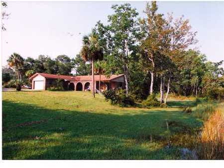The value is in the beautiful waterfront lot with a dock that is in protected water and opens to the bay. The house is livable and has lots of potential. Let your imagination run free and let this be your future residence. The kitchen is equipped with an electric stove, and a refrigerator. The den has a vaulted ceiling, brick floor, and brick fireplace and looks out over the water. There are 4 good size bedrooms. The master bath has a unique soaking tub and shower. The garage has access from the courtyard. Listing Broker/Salesperson has ownership interest in the property.