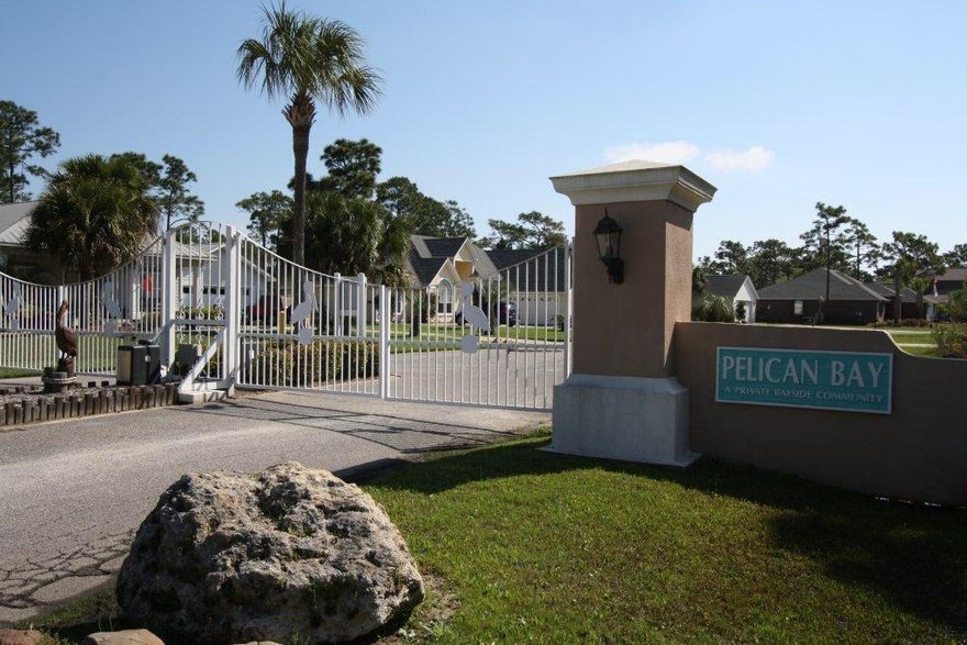 Located in the gated, bay front subdivision of Pelican Bay you will enjoy living in this exceptionally located community. Pelican Bay amenities include tennis court and bay front dock with park. You can pull your boat up to the community dock allowing easy loading for your family and friends or climb down the ladder for and play in the bay. LOW HOA's. Near shopping, restaurants and entertainment of Grand Boulevard, close to hospital and just minutes to the beach this lot is one not to pass up. Are you ready to build your dream home?