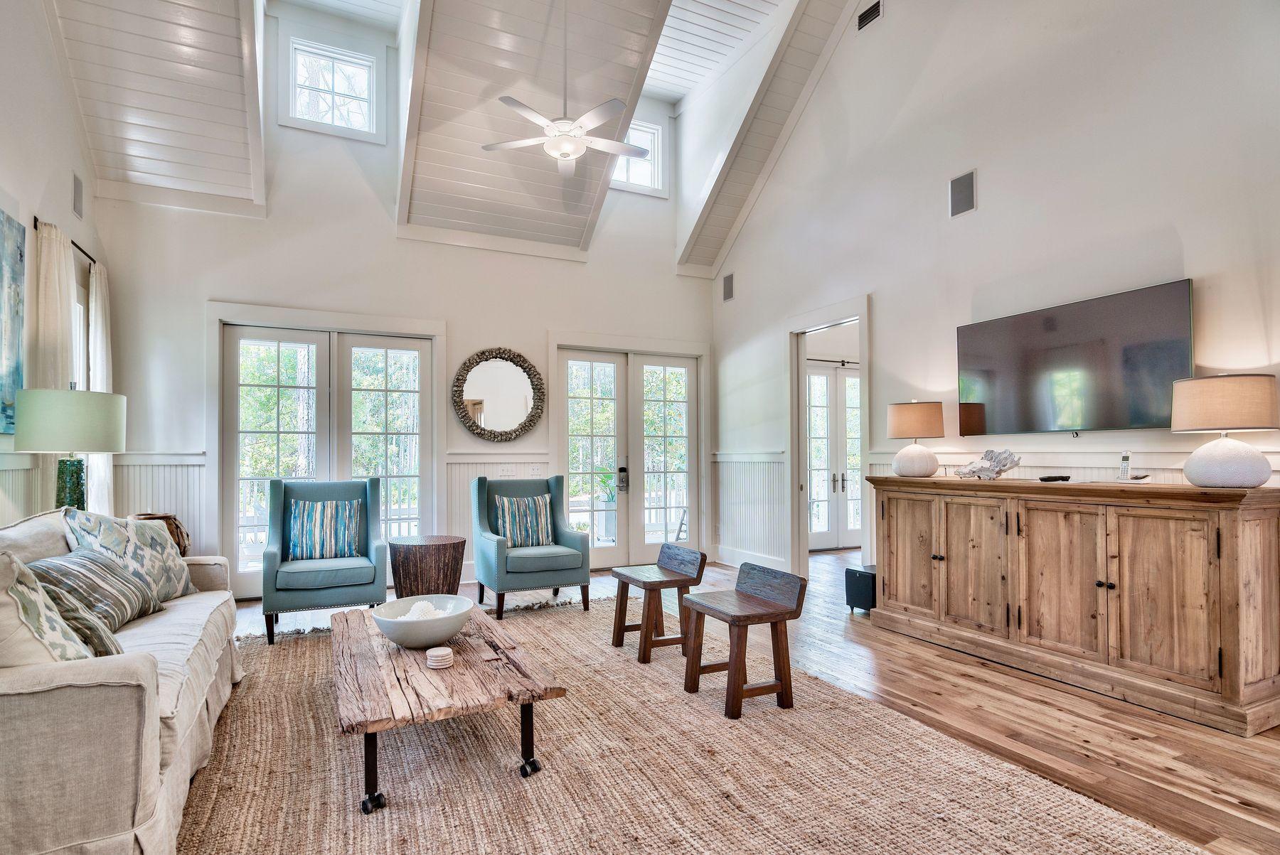 Serenity in nature defines this home in WaterColor Phase II that is surrounded by picturesque trees and preservation with porches on three sides. A quaint single-story cottage, this home is ideal for primary or secondary living or as a rental investment with bookings that convey. Warm walnut/hickory scraped wood floors carry throughout the living space and the three spacious bedrooms. A chef-inspired kitchen with Wolf and Sub-Zero appliances, a wine refrigerator, ice maker and pot filler will make entertaining at the island enjoyable. Custom cabinetry and elegant lighting add to its ambiance that will make you instantly relax into beach-mode. Throughout the home, you'll find quartz counters and warmth that exudes from the high ceilings and neutral decor.