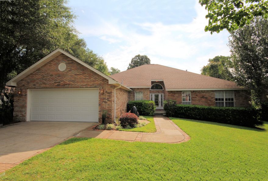 Gold Star Property! Completely updated expansive 4 bedroom brick home. Peace of mind comes w/living here, as this home is located in the gated community of Southwind, with no traffic in the quiet cul-de-sac. Upon entry, you will see the soaring ceilings, recessed lighting, and fireplace in the Living Rm, a formal dining rm, and French doors opening to the back deck. 6' wide-plank hardwood floors and new tile in all wet areas. Updates include: remodeled master bath w/granite counters, walk-in tiled shower, all new hardware, wood plank tile floors, and corner tub; remodeled kitchen (2013) w/granite counters, island, gas cook-top, stainless appliances, tile back splash. All updated light fixtures and fans, and exteriors doors. Energy savings w/newly blown attic