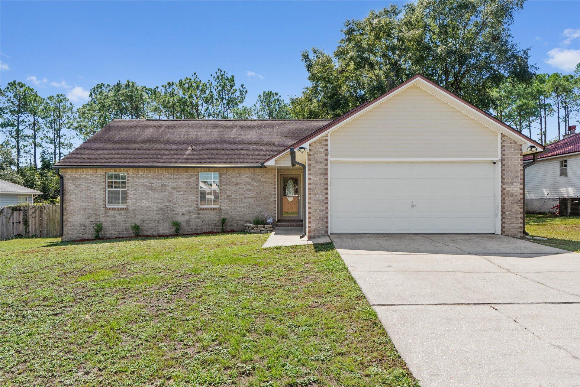 LOAN ASSUMPTION AVAILABLE! This charming home is move-in ready with key updates, including a 2016 AC, 2020 water heater, and 2015 roof. The spacious living area features vaulted ceilings and a cozy fireplace. The separate dining room and updated kitchen, complete with stainless steel refrigerator, make this home ideal for gatherings.You'll love the fresh paint and new LVP flooring throughout, as well as the primary bedroom with an ensuite bathroom that boasts double sinks and a large tiled shower. Additional updates include new gutters and the removal of popcorn ceilings, giving the home a modern feel. The oversized fenced backyard provides plenty of space for outdoor activities.  5 minutes to the interstate and about 25 to Eglin!