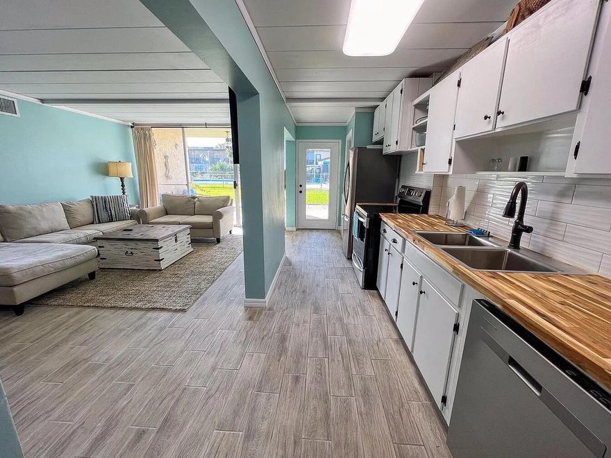 Beautifully fully remodeled ready to be your Vacation home or your VRBO, Airbnb short term rentals are allowed.  A month to month tenant already in place, this one is an easy vacation  rental or your own. Coastal decor with touch of class will make you feel right at home. Everything is 4 years old, piece of mind comes with it. The well designed kitchen, open living area allows for everyone to gather together.The covered patio has a great view of the sparkling pool and lush court yard. Making an easy walk to and from to cool off or have a party in the pool house.With access to to the inter coastal waterway, bring your jet skis, water crafts, paddle boards, even your boat can anchor to let family and friends on or off. While sipping your favorite drink and watch the beautiful sunsets