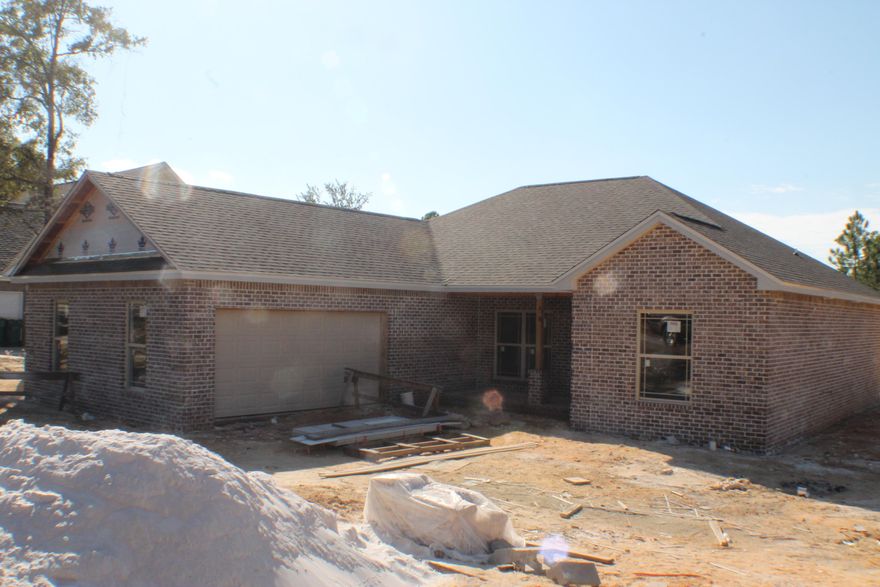 All Brick custom home! Location Location location! Just north of CHS, Davidson, Banks, Movies, Restaurants, Winn Dixie and the new Publix under construction!! New Home Large lot! 3 Bedroom, 2 Bath home with many upgrades! Premium Counter Tops, Custom Built Showers, Free Standing Tub in Master!! Cathedral ceilings with wood ceilings. Laminate wood floors, tile in the bathrooms! Under construction. Irrigated lawn! Come home today! Local custom builder. See photo section for floor plan!