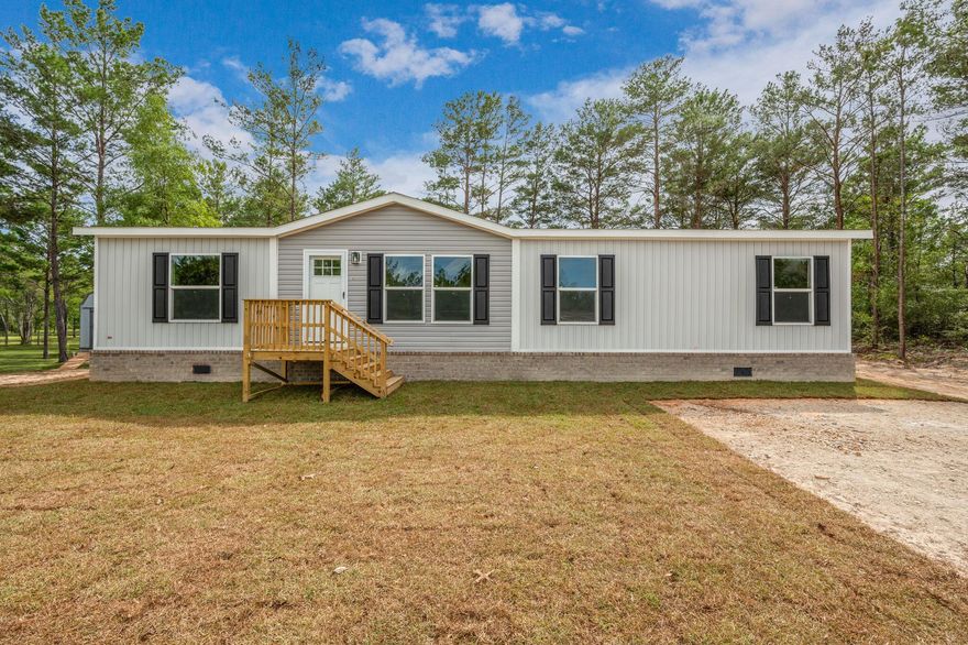 Explore this beautiful brand new manufactured home on 1/4 of an acre with access by county maintained road. Spacious & stylish with an open floor plan and split bedrooms. This home offers 4 Bedrooms, 2 Bathrooms, a flex space, den, coffee bar & more! Check out the kitchen island and whoa at the cabinets! When you first drive up you will notice the upgraded brick skirting for added curb appeal and stability. This home is move in ready & you could be its first occupant.