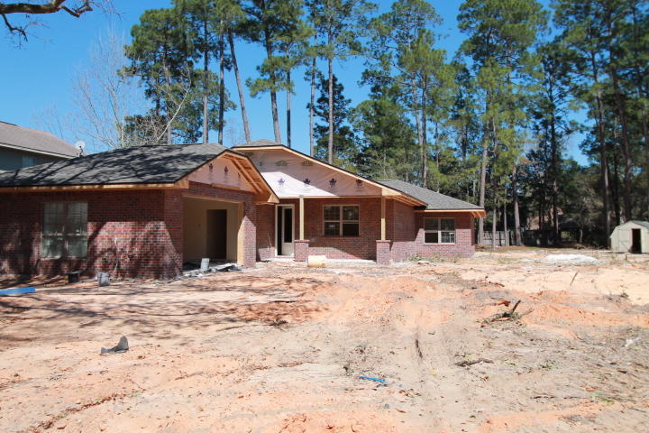 This picture is of the home next door, same plan. different elevation, will update soon. Awesome new floor plan by multiple award winning builder, and 2017 Parade of Homes award winner! This 4/3 custom brick home and has super curb appeal, and is located in a very quiet neighborhood with a large yard (+/- 1/3 Acre). 10 Ft. ceilings, impressive crown moulding, 8 foot interior and exterior doors, custom milled window and door casings, and wood look tile flooring, will be throughout the main living areas, and master bedroom. As you approach the front of the home, you will be quite impressed. The covered porch is very welcoming, and the colonial style, glass front door, makes for a grand entrance. The formal dining room is at the right of the home's front.
