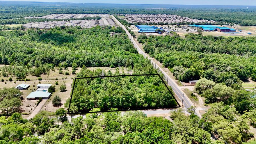 Beautiful mostly wooded lot in the center of lots of development! Legal description calls it 3 lots.Lots 1,2,3, of Blk A Power line runs right beside property. Water at the street! Perfect for one big house on aprox 2 acres or maybe up to 3 homes!Paved roads giving easy access! Central to shopping! Elementary and middle schools just 1000 ft away approx. Hurry and make this prize property yours today!