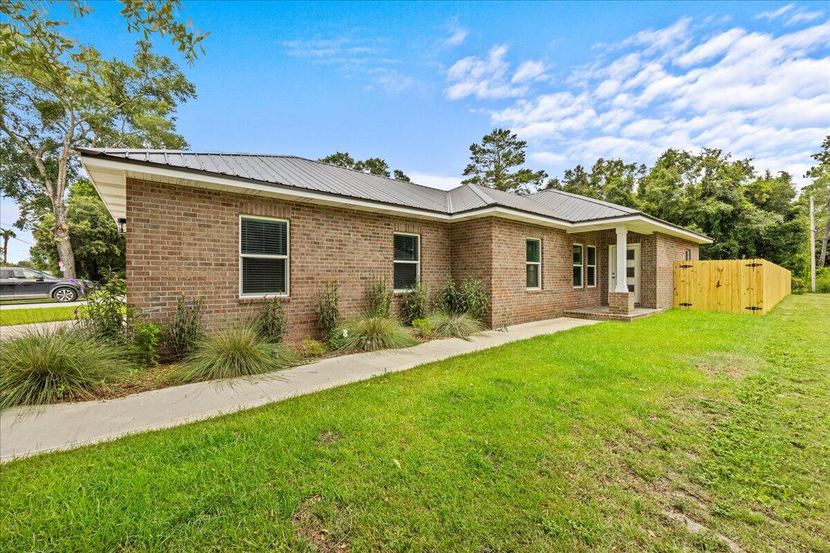 Built in 2023, this beautiful brick home features 3 bedrooms, and 2 bathrooms. Offering an open floor plan with LVP and tile flooring throughout. The kitchen boasts GRANITE countertops, stainless steel appliances, and white shaker style cabinetry.Large primary bedroom with en-suite bathroom; featuring granite countertop, tile shower, and a walk-in closet with built-in shelving.Desirable split bedroom floor plan with 2 additional bedrooms and a full bath with a shower/tub combo. This home comes complete with a 2-car garage, and durable metal roof. Located in Villa Tasso, one of the fastest-growing communities in the Niceville area.