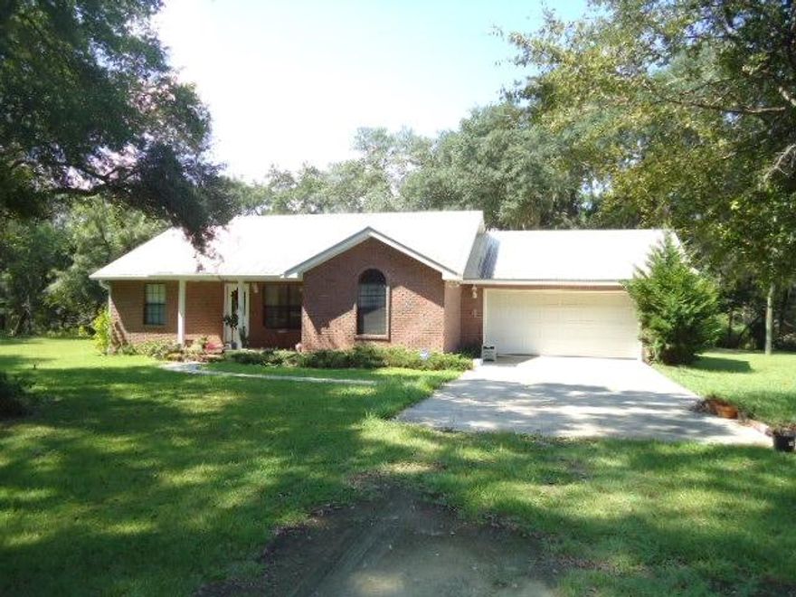 20 acres of land with at least 5 acres already clearing. Big Beautiful Oak trees with a lovely brick ranch one level, three bedroom, two bath home. Double car garage, with another one car garage with workshop and bathroom, with 768 sq. ft. in it. A carport for the boat and plenty of land for a garden or anything else you want or need. This home was built in 2004 and is well maintained, granite countertops, two baths with showers, split bedrooms and a florida room.Plenty of room for horses or whatever you choose. call for your appointment today.