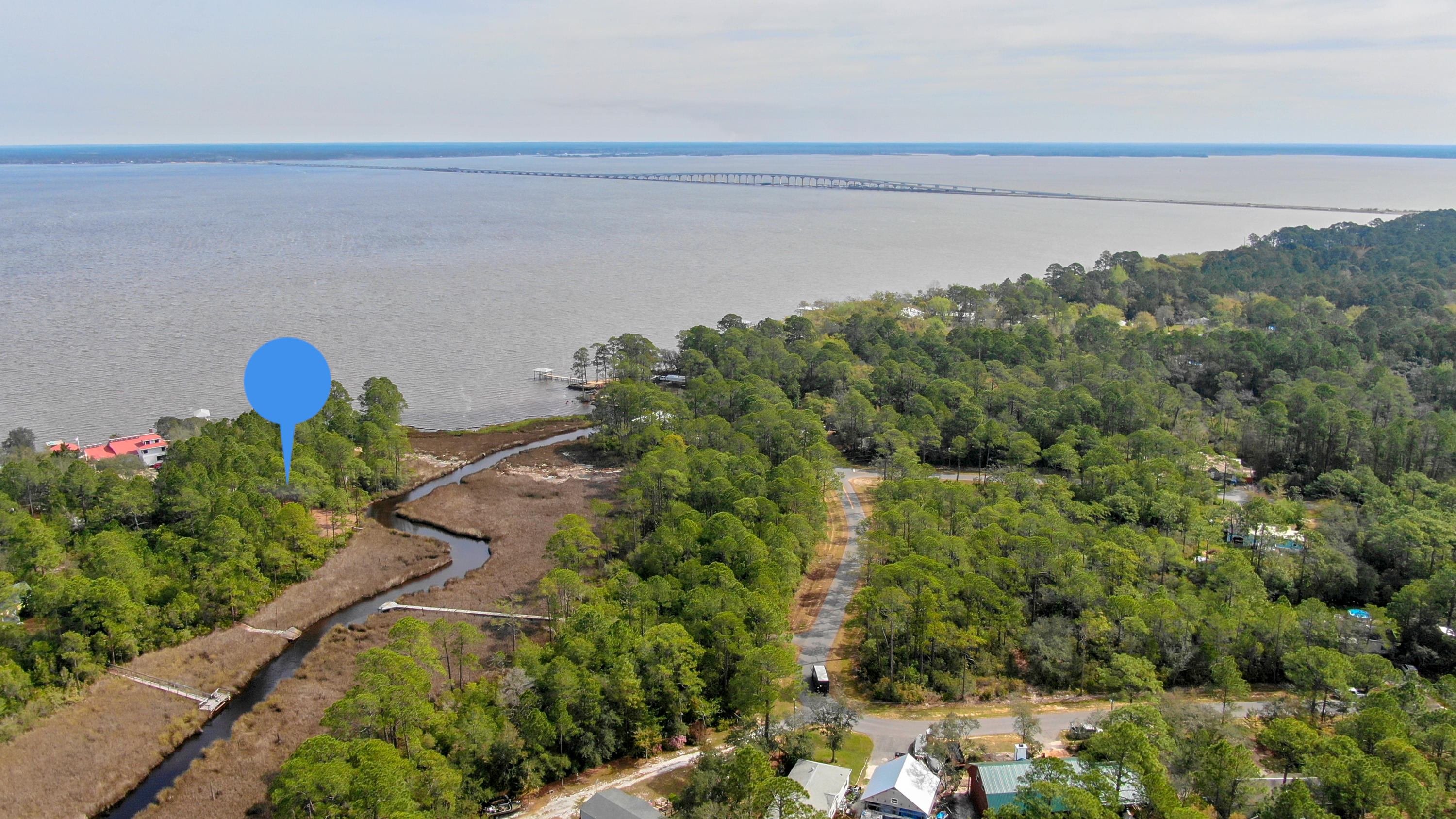 Great location to build your dream home with unobstructed bay views and sits next to county park land that will never be built on. Lot is surrounded by lush natural landscape which provide all the quiet and privacy that is hard to come by. Property is nestled north of Chat Holley Road, far enough away from the hustle and bustle of Highway 98. Lot features 203 feet of stream/creek waterway that is fed direclty from the Choctawhatchee Bay. Perfect backdrop for paddle boarding, kayaking and small water craft.Although, the property is secluded, you will still be within minutes of the Emerald Coast's best beaches, local favorite restaurants, shopping and attractions. You could say this lot is surrounded fun!