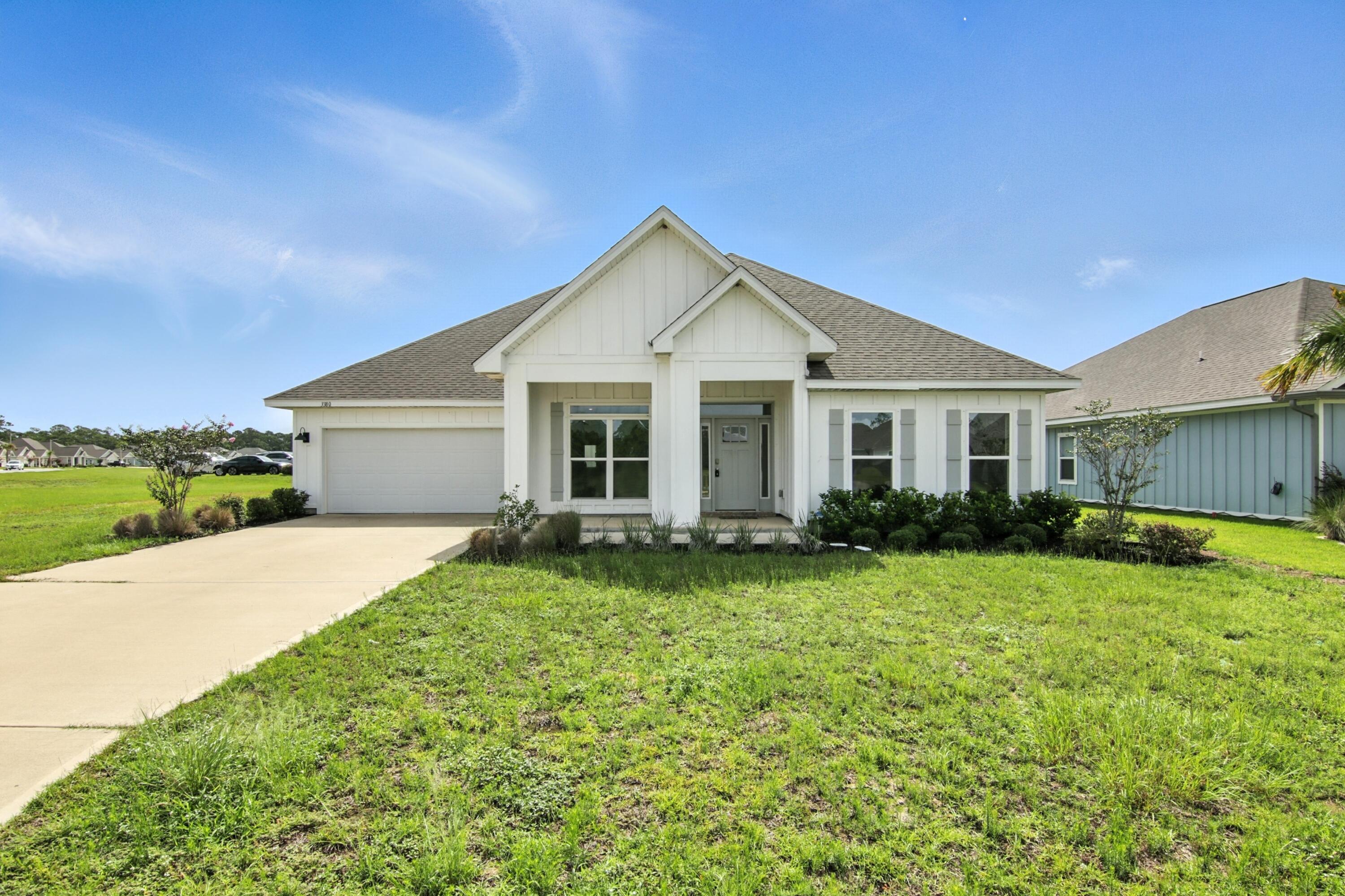 Welcome to this stunning 5-bedroom, 3-bath home built in 2022, offering peace of mind with a 10-year builder's structural warranty. If VA eligible ask about assumption loan option. This spacious home features an open-concept layout with tray ceilings, recessed lighting, crown molding, luxury vinyl plank flooring throughout, and custom fit plantation shutters. The kitchen is a chef's dream with stainless steel appliances, granite countertops, built-in wall ovens, a built-in microwave, and a generous walk-in pantry. The split floor plan offers a private primary suite with a large walk-in closet, dual vanities, garden tub, and separate tiled shower. Enjoy a fenced backyard, covered patio, and two-car garage in a prime Gulf Breeze location. This home is an easy 30 minute commute to Hurlburt Field and 40 minutes to NAS Pensacola.