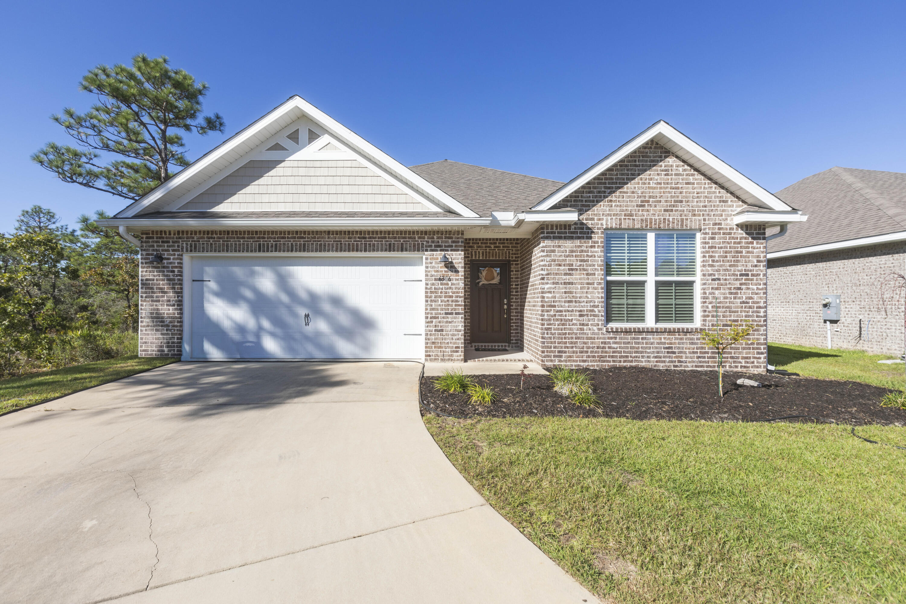Beautiful 4-year-old Craftsman-style all-brick home in the desirable Cambridge Park, ideally located off Hwy 98 and near the sugar-white beaches. This home sits at the end of a spacious cul-de-sac, offering extra privacy, minimal traffic, and a great space for outdoor gathering. The welcoming foyer opens to a split-bedroom, open-concept layout with crown molding, granite countertops in kitchen and baths, and luxury vinyl plank flooring throughout with carpet in the bedrooms. The kitchen features stainless steel appliances, shaker cabinetry & plenty of counter space. The private master suite includes tray ceilings with crown molding and an en-suite bath with dual granite vanities, separate shower, and garden tub. It also includes a large walk-in closet that leads into the laundry room. Enjoy the fully fenced (will be completed in the following week) backyard with a covered back porch. Solar panels will be paid by sellers at closing so buyers can appreciate the perks of solar living with low electric bills in this energy efficient home. Don't miss this stunning home!