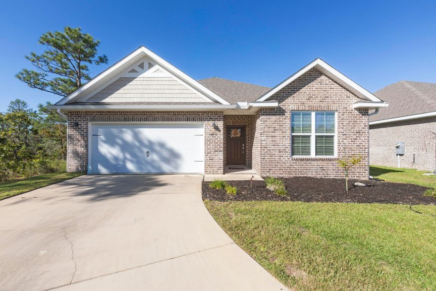 Beautiful 4-year-old Craftsman-style all-brick home in the desirable Cambridge Park, ideally located off Hwy 98 and near the sugar-white beaches. This home sits at the end of a spacious cul-de-sac, offering extra privacy, minimal traffic, and a great space for outdoor gathering. The welcoming foyer opens to a split-bedroom, open-concept layout with crown molding, granite countertops in kitchen and baths, and luxury vinyl plank flooring throughout with carpet in the bedrooms. The kitchen features stainless steel appliances, shaker cabinetry & plenty of counter space. The private master suite includes tray ceilings with crown molding and an en-suite bath with dual granite vanities, separate shower, and garden tub. It also includes a large walk-in closet that leads into the laundry room. Enjoy the fully fenced (will be completed in the following week) backyard with a covered back porch. Solar panels will be paid by sellers at closing so buyers can appreciate the perks of solar living with low electric bills in this energy efficient home. Don't miss this stunning home!