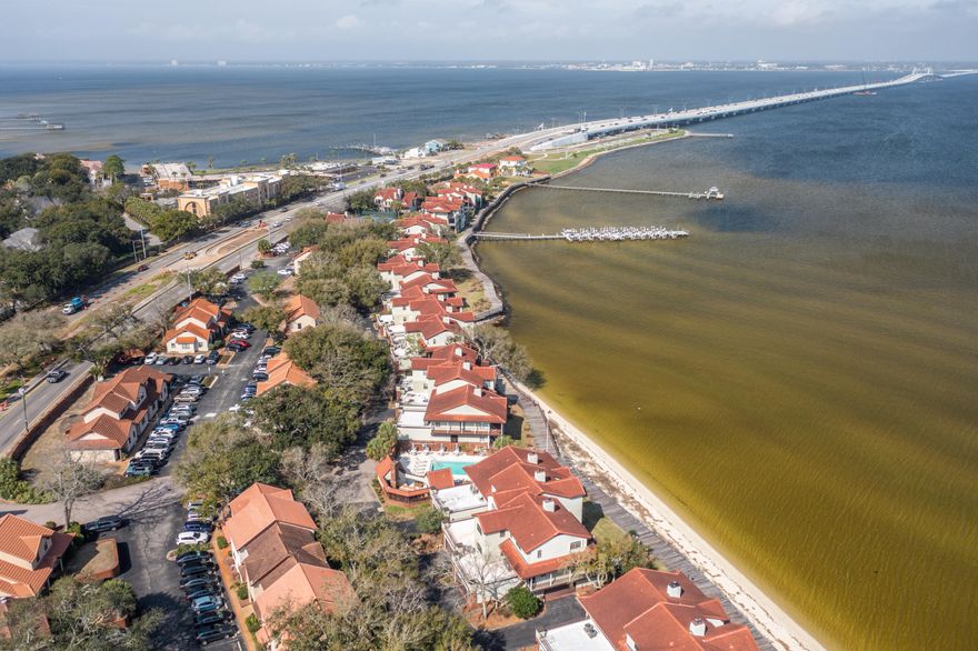 Waterfront luxury living on the Bay! Bay Breeze is a gated property in the coveted Gulf Breeze Proper community. This 2 bed 2 bath with a large 3rd bonus room ( with walk in closet) offers you single floor living. Stunning  Bay water views hit as soon as you step inside the spacious living area. The white and bright updated kitchen comes with newer appliances. A large covered deck off the living and dining room gives you the pleasure of enjoying sunrises, sunsets and bay breezes. The primary bedroom also boasts a large, private covered deck with access to the boardwalk. The primary bath has double sinks, 2 large closets and tons of storage. Down the hall you'll find another large bedroom and the bonus room with the guest bathroom.