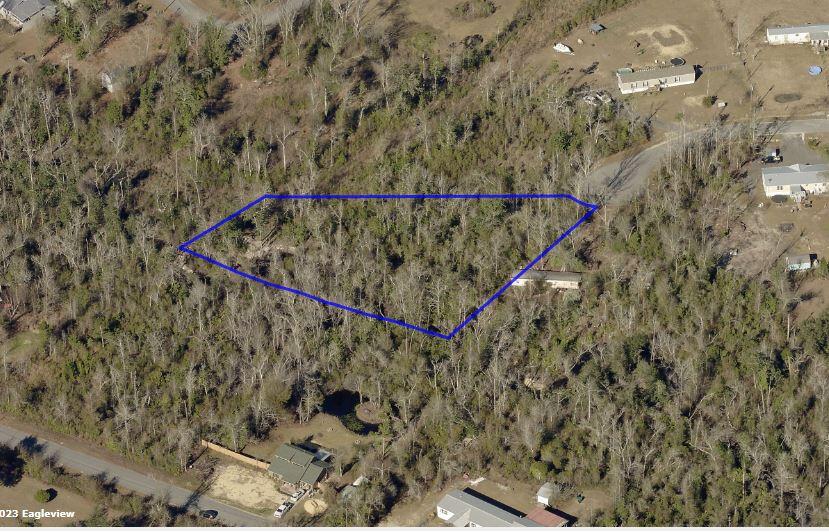 Just 13 miles from Panama City's beaches, this wooded vacant land offers a perfect setting for a campground. With Bear Creek flowing along the southern border, it's an ideal spot for nature lovers and outdoor adventures. Enjoy fishing, hiking, and serene nights under the stars in this tranquil retreat. Create your own escape in this beautiful, nature-filled paradise!