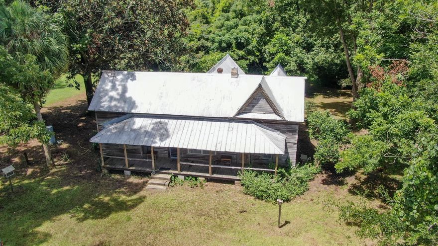 Meet...the Magnolia House. She is what some may pass by without a second look. Or call old and worn out. Yet others see the beauty within her, which only needs a little time & love to restore her full charm. Named after the even-then giant magnolia tree in the 1950's, she is the epitome of southern charm. With original floors, doors, tongue & groove walls and soaring ceilings, you are transported to a simpler time. As told to me, the stage coach stopped here and she also served as the post office! The front porch spans the width of the home on a lush, level, appx 2/3 acre lot w/ palm and grapefruit trees. The 1950's living room wall mural is a treasure. Some renovations begun are insulation, new wiring in 2012 and new well in 2008. Who is ready to restore her? Cash offers only please.