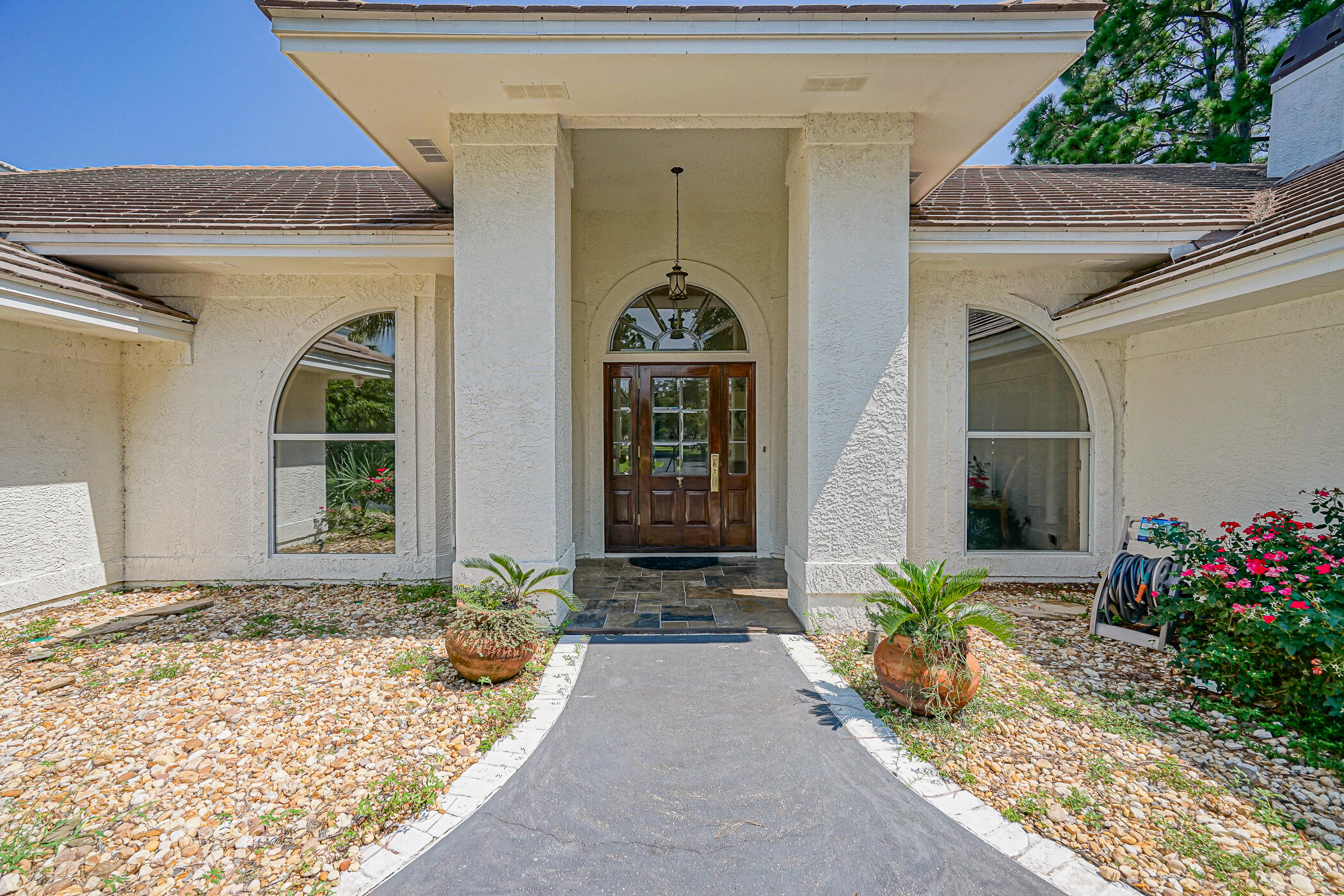 Newly Renovated...New flooring, new painting, renovated boat house. This beautiful Bay Front home has over 1 acre of lush, secure property. Gated home with it's winding entrance, through Florida Oak trees is a Florida estate that everyone seeks in today's world. Home features a newly upgraded dock and heated swimming pool with a newly completed Carriage house that features 480 sf  of private office space. Ample garage space can house up to 6 cars and all your toys, 20 foot ceilings throughout the primary living space with a chef's open floorplan kitchen. Hugh Master suite with a steam shower, large spa tub and a screened Lanai. The sun room connected to the kitchen area also features a relaxing screened Lanai. Dock 3000LB lift