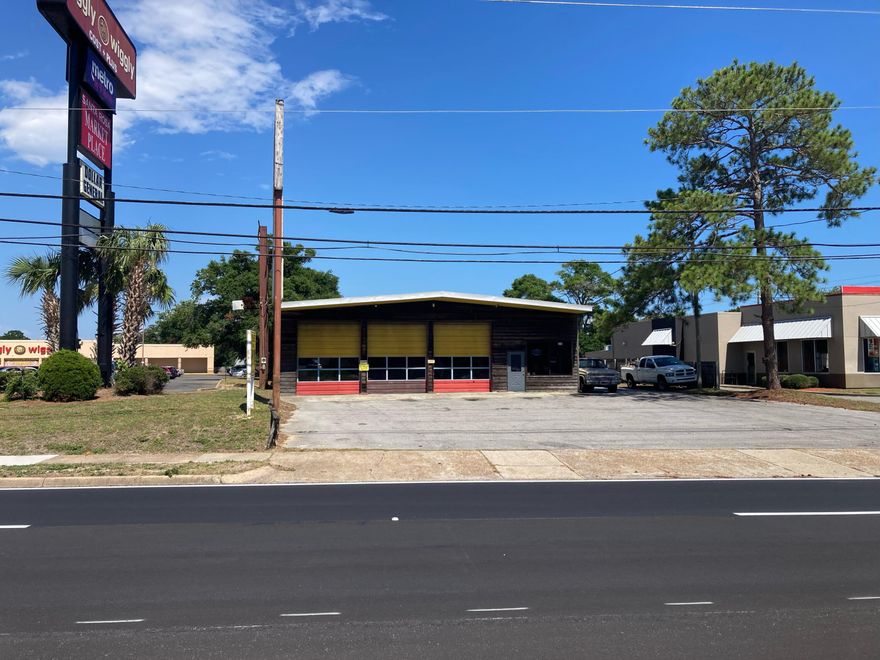 Located on Mary Esther Blvd. adjacent to Burger King and across the street from Santa Rosa Mall. The property is improved with a waiting area, 2 offices, 2 bathrooms and a large open bay area with seven overhead doors.