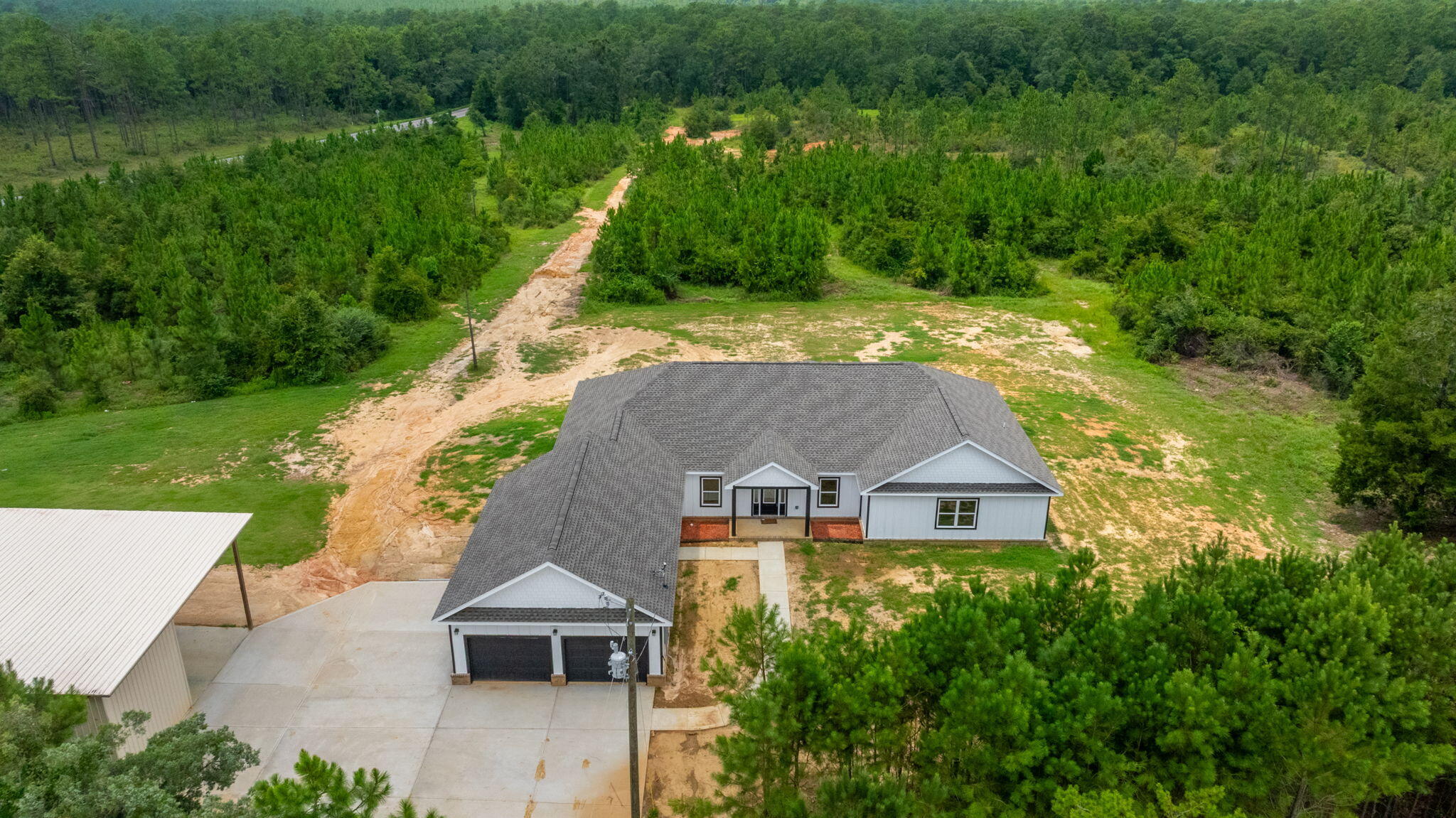 Welcome to your brand new custom farmhouse retreat on 12 stunning acres This charming home features 4 spacious bedrooms and 3 bathrooms. Each and every aspect of this home has been designed for comfort, style, and functionality. It boasts a bright open-concept layout and a a gourmet kitchen .with a large center island and stainless steel appliances. It has beautiful LVP flooring through out the entire home. This property also has a massive 30x 60 pole barn.Outdoors enjoy the endless possibilities of your 12 acre property. Perfect location for horses, gardening ,or just soaking in the serenity of this location as it is adjacent to the blackwater forest.