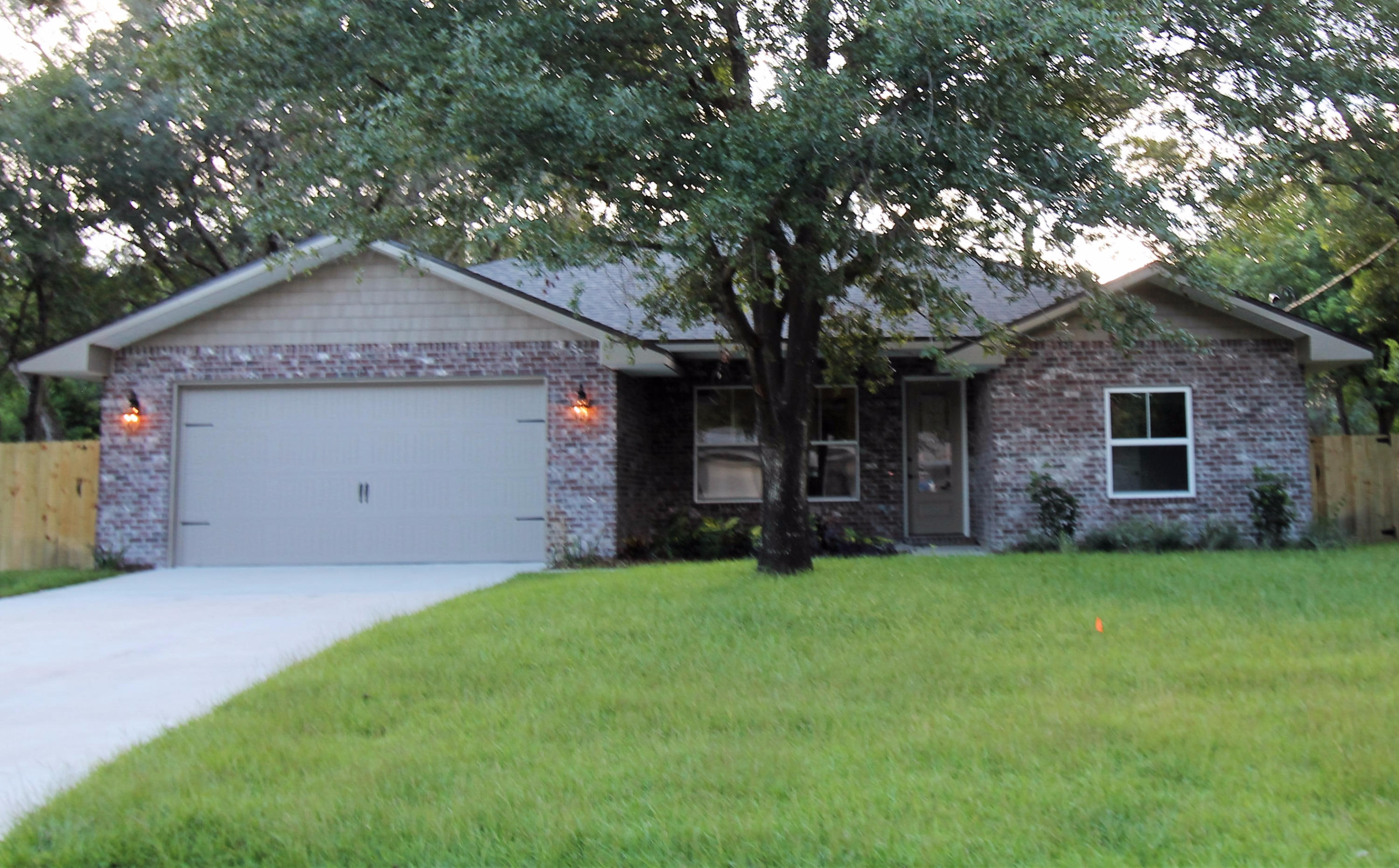 Awesome new floor plan by past parade of Homes, multiple award winner! This 4/2 custom brick home has super curb appeal. There are 10 ft. ceilings w/ impressive crown molding, tile flooring, and 5 1/4'' baseboard throughout the main living areas. As you approach the front of the home, you will be quite impressed. The covered porch is very welcoming, and the gorgeous 8 ft. leaded glass door, makes for a grand entrance. The formal dining room is at the left of the home's front and has an attractive arched entryway that leads to the kitchen. The chef's delight kitchen boasts custom maple cabinetry, granite countertops, a wet bar with beverage cooler, a large pantry, and stainless appliances, (including an oversized commercial grade frig./freezer) and a gas range. At the right of the home's entrance is bedroom one, continuing down the hallway is the guest bath, then bedrooms two and three. The oversized greatroom is located at the rear of the home and opens to a covered porch, which is perfect for entertaining. The master suite is oversized, has 2 large walk - in closets, a linen closet, a walk - in shower, a whirlpool garden tub, and a double vanity. The laundry room is at the rear of the kitchen, and has a door which opens to the garage. The yard will be beautifully landscaped and comes complete w/ a well, sprinkler system and timer. Insurance will be very reasonable, as home is built to today's code and window coverings are being provided for storm protection. Home has a Taexx ''in the wall'' pest control ll be beautifully landscaped and comes complete w/ a well, sprinkler system and timer.
