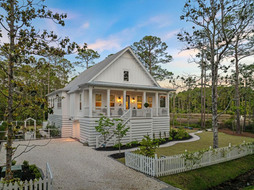 Nestled among the forest pines, this newer construction home is a haven of serenity. Located on a large lot overlooking Hogtown Bayou, this contemporary Florida cottage has a private boardwalk leading through the reeds to a fishing dock. Enjoy sunset drinks and waterfront views or launch kayaks, paddleboards and jet skis right from your own backyard. Steps lead up to the open porch of this elevated home, which is perfect for enjoying sunshine and shade in all seasons. Lofty 10-foot ceilings welcome you inside, where the living room is saturated with natural light through multiple windows. Engineered hardwood flooring flows through a synergy of open spaces, each with its own designated purpose. Anchored by a gas stone fireplace, the sitting area offers a place to kick off your shoes and relax. A generous dining area provides a space for everyday meals and entertaining beneath a contemporary light fitment. Head into the all-important kitchen that's designed for channeling the inner chef. White Shaker-style cabinets stretch to the ceiling while tiers of drawers store utensils and smaller items closer to hand. Veined Cambria Brittanicca quartz countertops extend onto a large island that accommodates a stainless steel butler's sink, dishwasher, microwave and still has space for four diners. Tucked away, there's a handy wet bar with a beverage refrigerator and shelves for holding glasses, mixers, and more. Three beautifully designed bedrooms boast custom closets, elegant Roman blinds and blackout shades. After a peaceful night's sleep, awaken to water views and access to the balcony from the second bedroom. The master suite is particularly enviable with space for a quiet sitting area and another door to the balcony. A wall of windows frames serene views of Hogtown Bayou. The adjoining bathroom has an oval soaking tub, a glass shower enclosure and a twin vanity, all enhanced by a feature tile wall. A separate laundry room, home office space, bunk area and a guest bath round off the first-class amenities. 

There's no shortage of outdoor living space with a lengthy screened balcony on three sides providing space for relaxing, dining and socializing beneath gently turning fans. Built on 10-foot pilings, the home includes a garage for storing bikes, garden equipment and water toys beneath the house. A Bahama rock driveway with automatic gates ensures privacy and security for part-time residents. The well-tended garden provides a riot of summer color, grass for children to play, and the opportunity to grow your own fruit and veg, if desired. Close to the Cessna boat launch, owners can look forward to endless watersports and happy days spent at one of the beautiful white sand beaches nearby. Gulf Place and an abundance of restaurants and shops round off a variety of activities that can be enjoyed from this most desirable location.