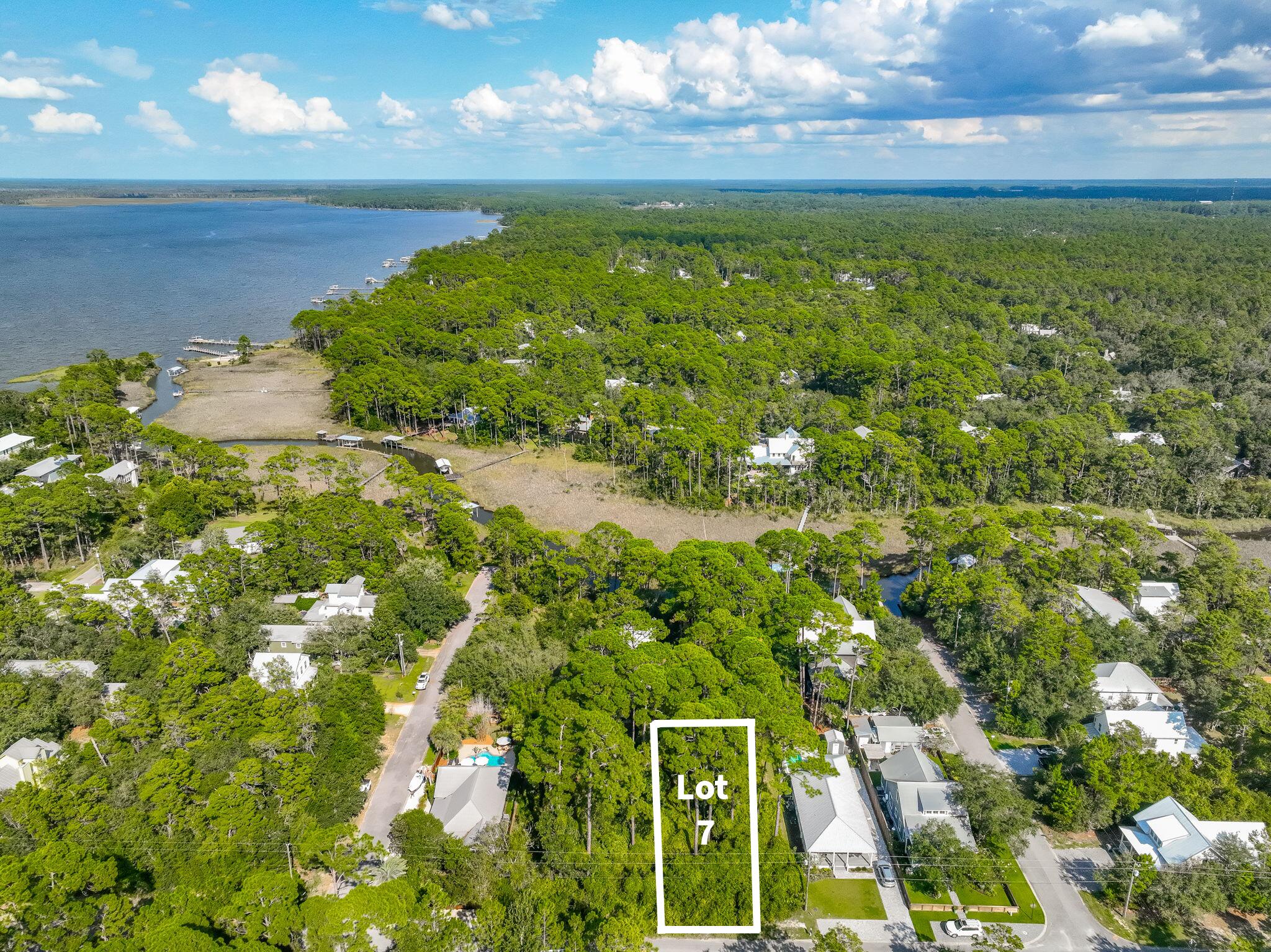 This lot offers the perfect blend of bay access, natural beauty, and 30A convenience - just a few streets from Choctawhatchee Bay, where you'll find a community dock and a nearby county park for kayaking, fishing, and sunset views. Less than four miles away, Grayton Beach awaits, separated only by the quiet of Point Washington State Forest. Just around the corner, Eden Gardens State Park invites you to explore its scenic trails, picnic pavilion, and grills for a true taste of Old Florida charm. This growing community of classic Florida cottages offers rare freedom, no HOA and no buildout timeline - giving you complete control over your home's design.Want more space? The adjacent .17-acre lot is also available, allowing you to combine both properties for an expansive homesite perfectly suited for a custom coastal retreat, pool, and outdoor living. With WaterColor, Seaside, and all the best dining and shopping along 30A just minutes away, this is your chance to create a private sanctuary in one of South Walton's most peaceful settings.
Lots 7 & 8 include wetlands but are recognized as buildable lots of record by Walton County. Pricing reflects the presence of wetlands and associated considerations. Wetland study available.