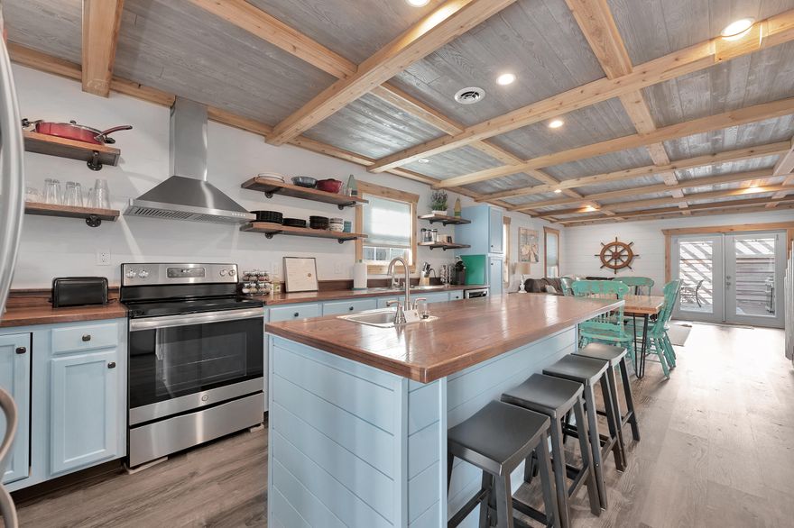 This beautiful, remodeled townhouse on Holiday Isle is a great investment property. Located on a private street with and a yearly Master HOA fee of $285/yr. Home remodel was completed in 2019 and features an open floor plan downstairs with all new appliances with custom countertops. The upstairs has 2 bedrooms each with their own private bathrooms. The master has an all cedar walk-in closet and the bathroom has a double vanity with walk-in shower. The balcony on the front gives you both a view of the gulf and harbor. The home features LVP flooring for easy maintenance, cedar ceilings throughout the upstairs, large back deck for entertainment, and deeded beach access for an easy walk to the beach. This home is a short-term rental that has been a proven money maker. Sold Furnished.