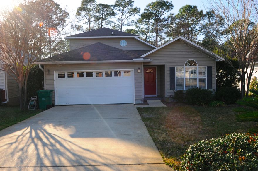 Must See, better than new Bluewater Bay area home. Top drawer home featuring granite countertops, eat in kitchen with maple cabinets, wood plantation shutter, gorgeous lighting fixtures and granite breakfast bar pass-thru into family room. Family room has cathedral ceilings, new engineered hard wood floors with half bath and interior laundry. First floor Master Suite has new carpet, a walk in closet, double vanities in bath. Bonus room is currently being used as an adorable playroom and office. Bonus room leads to an incredible multi-tiered deck. Beautiful, professionally landscaped and fenced yard with new irrigation system and plenty of space to entertain. Back yard backs up to wooded Eglin Reservation. Upstairs are 2 additional bedrooms with new carpet and full bathroom.