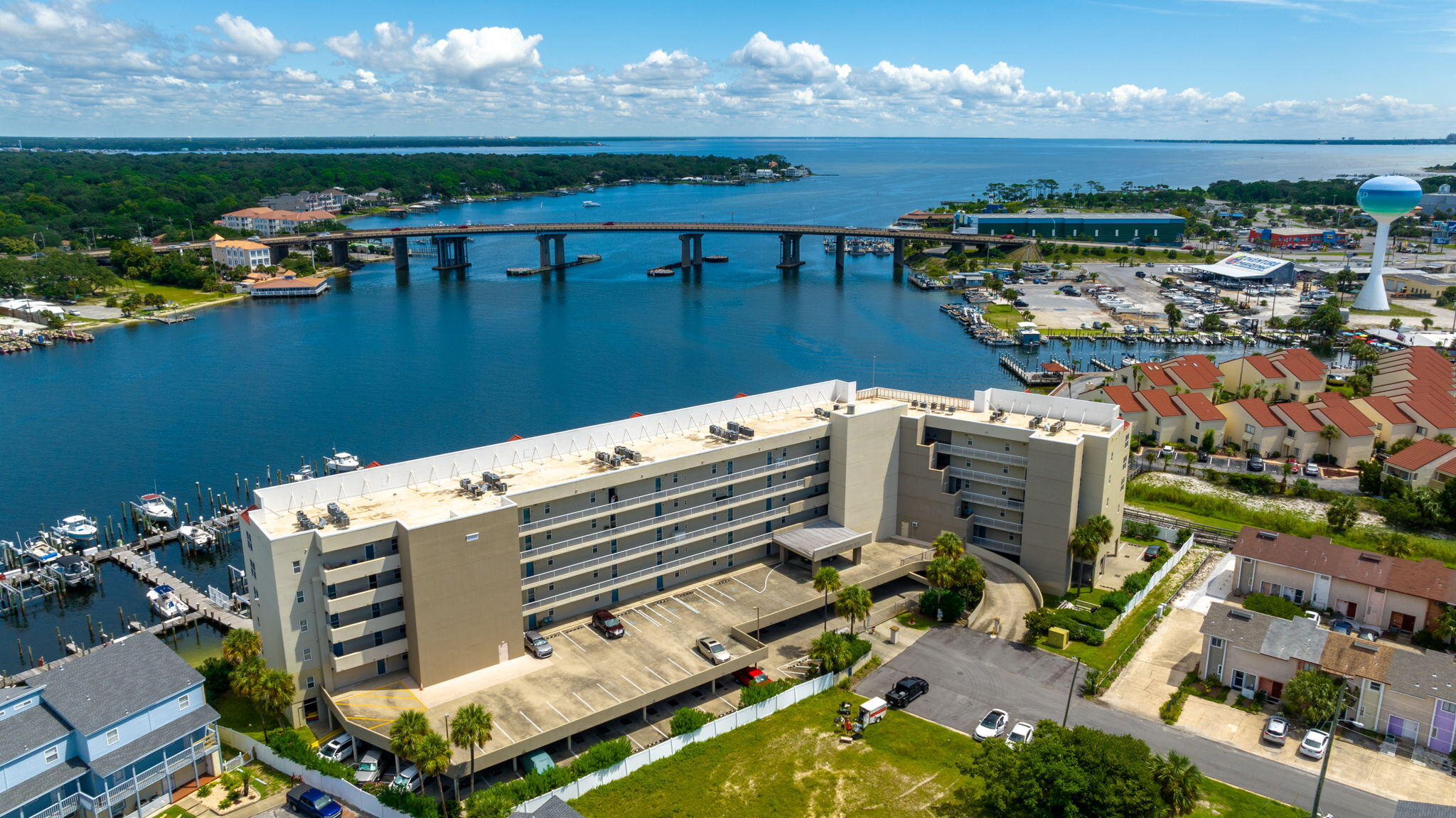 FABULOUS PRICE & SELLER WILLING TO PAY UP TO $5000 TOWARD CLOSING COSTS, PRE-PAIDS, ESCROWS & RATE BUY-DOWN! This lovely condo has it all! Spectacular views of Santa Rosa Sound, boat slip (#2) designated garage parking (#34) & locker storage! Enjoy Concerts in the Park, fireworks & the Billy Bowlegs Festival from your private balcony! Beautiful granite countertops! Plantation shutters! Electric shades! Walk-in showers! Breakfast bar! Laundry area accommodates full-size washer/dryer! Open floorplan with 9' ceilings! Storm-rated sliders & HOA-approved front storm door! Community pool & spa with adjoining bath! Development currently allows short-term rentals!