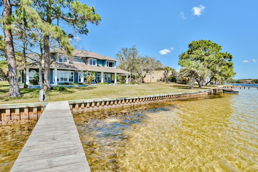 Welcome to 15 Paradise Point, Shalimar Florida. This immaculate one-owner custom-built home is optimally positioned on a half-acre lot and features panoramic views of Poquito and Gariners Bayou. This amazing 4400+ sq ft home includes 4 bedrooms, 3.5 bathrooms, an office, a bonus room, and a 2 car garage with a workshop. The home displays beautiful bayou views in the master bedroom. front room, living room, kitchen, a second bedroom, and the bonus room. Built with entertaining in mind. The front room includes a wine fridge and wet bar. The kitchen includes maple cabinets, granite countertops, stainless appliances, double ovens, and a gas range stove. The kitchen features an open concept, perfect for interacting with family and friends in the living area while making their favorite meals.