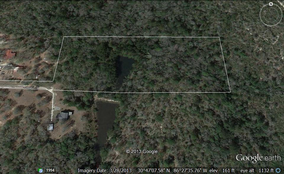 Beautiful, almost 7 acres, wooded with a 1/2 acre pond. The property is located appx 400 ft off of the road, but has a deeded 28 ft access point. The owner says the pond is spring fed, and there is an overflow pipe in the pond thru the dam. This property is pristine, with beautiful trees, an active water supply, privacy, and wildlife. The bulk of the property starts near the 3rd light pole and lies east. Boundary survey has been complete and is available for potential buyers. Drive has been cleared, so you can access bulk of property down driveway.
