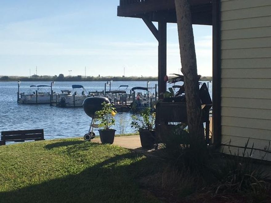 Waterfront 2 bedroom, 1 bath unit. Spectacular view from unit/patio. Complex has dock, pool, tennis court, club house, laundry. Property is well maintained. Beautiful sunsets from patio. Great location. Unit was recently updated with new cabinets, corian counters, and new appliances as well a new a/c unit. Unit is occupied, shown by appointment only.