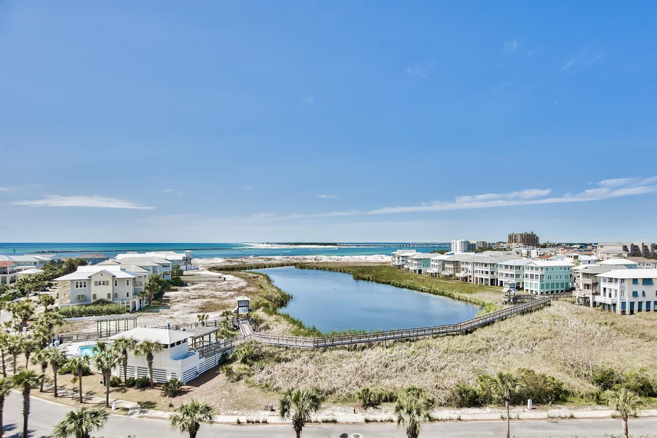 This top floor beauty is an Income-producing condo on the Jetty East rental program. 2023 gross income was $66,000. This lovely, updated 2 bedroom, 2 bathroom condo is being sold fully furnished. Gorgeous views of the East Pass and the Gulf! Spa-like bathrooms and granite throughout bathrooms and kitchen give an updated feel. Kitchen has stainless appliances, double sink, backsplash and custom cabinets. In unit laundry for convenience. Details such as built in USB receptacles offer convenience and ease when staying away from home. Tile floors throughout and no carpet. Hot water heater has been replaced as well. Jetty East Amenities include a 2400 sq. ft. pool with sun deck, hot tub, beach side pavilion with charcoal grills, tennis courts, pickleball, fitness room, kid's activities, music entertainment, shuffleboard, owners meeting room and of course 900 feet of Sugar White Sand! There is 24 hour security in place as well. Call today to schedule a tour.