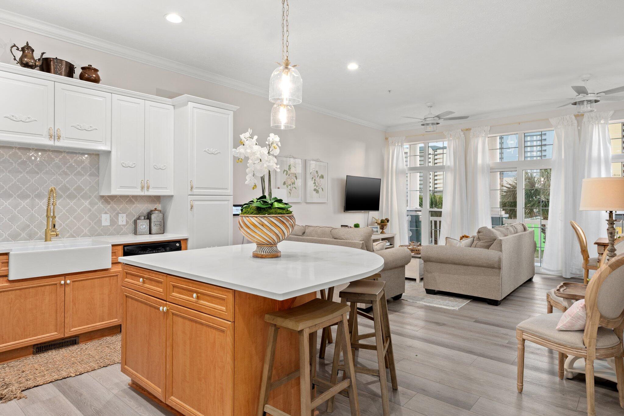 Fully renovated & professionally designed in 2022, this elegant French-inspired townhome is just a short stroll from the world-famous white sand beaches of Panama City Beach. The top floor features a luxurious master suite with Gulf-view balcony, spa-like ensuite with a soaking tub, and custom tile work. The main level offers an open living space full of natural light, a modern kitchen with stainless appliances, and ideal flow for entertaining. The lower level includes a guest bedroom with ensuite bath and garage access. Enjoy the community pool, convenient location to nearby attractions, and turnkey ownership with it coming fully furnished. Ideal for a 2nd home with short term rentals allowed to offset expenses. HOA fees include base-value property insurance. Buyer to verify all info
