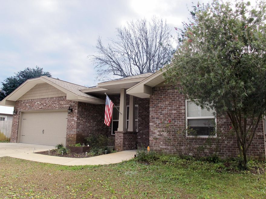 Beautiful all-brick 2016 home by award-winning Acree Construction features many custom details: wood-look tile floors throughout the home; 10-foot raised ceilings with Spanish lace finish; impressive crown moulding in the main living areas and master, and 5 1/4'' baseboards in the main living areas and all bedrooms. Altogether elegant!An open concept dining room is at the front of the house, and an oversized great room at the rear. The kitchen is the heart of this home, with a wrap-around breakfast bar that can seat up to 6. Custom maple cabinetry complements the expansive granite countertops and offers more than enough storage along with not just one, but two pantries. The signature Acree refrigerator/freezer is the centerpiece of the stainless appliances, (keep reading)