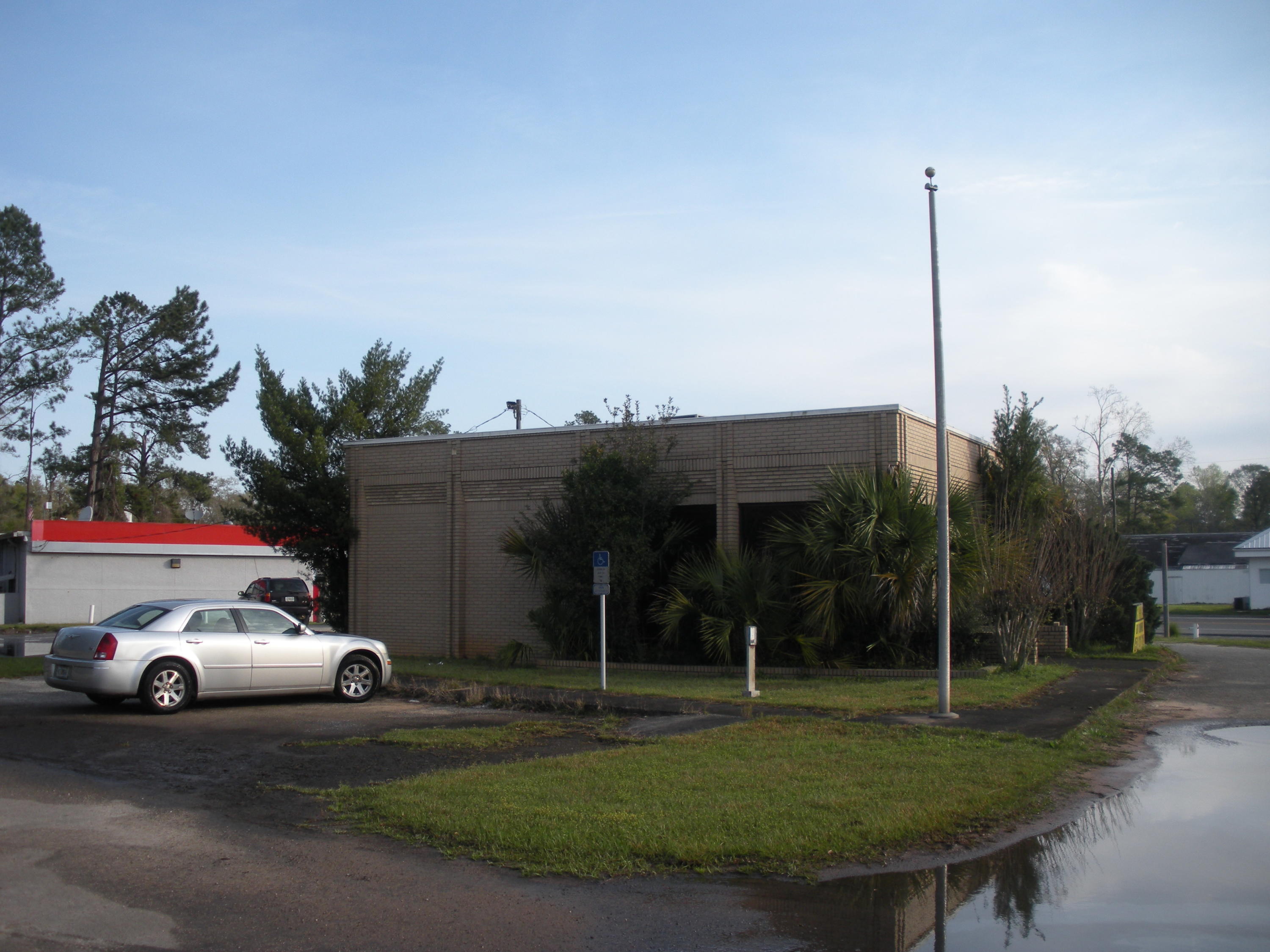 This your opportunity to purchase an approximate one acre lot w/ solid building (former bank w/ built-in safe) that has maximum exposure on the NW corner of Hwy 90 and Hwy 81 in Ponce De Leon, one mile North of I-10! Valuable corner alone is worth $300k alone, but you get a solid bank structure, too! Don't want a bank? Renovate it to make it exactly what you want! Expand the 1,200 sq ft of heated & cooled space to put your retail store, convenience store, restaurant, office, hotel, or something even better! This pie-shaped lot has over 200 ft of frontage on highly visible convergence at the NW corner of Hwy 90 and Hwy 81! That makes if visible from each direction and fronting major state highways! Survey available. Call for your appointment, today! Cheers!