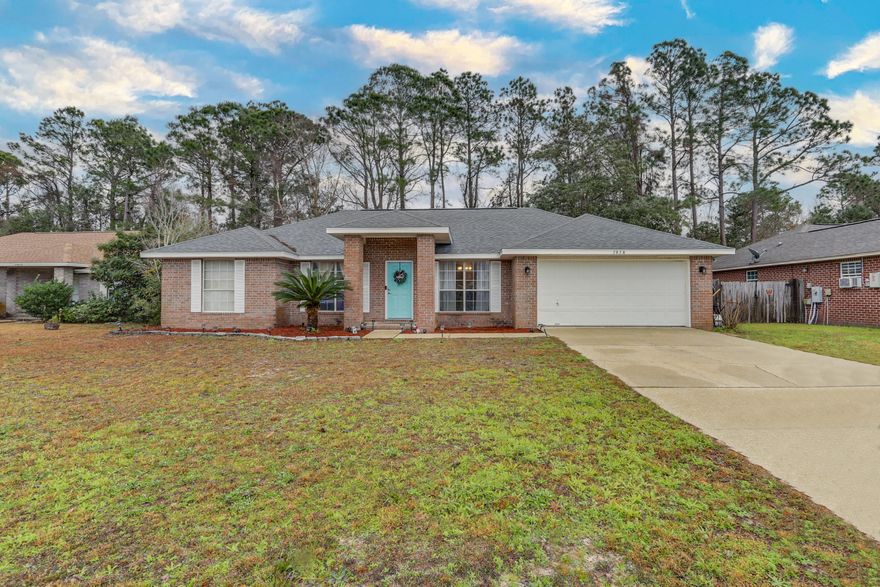 Villa Danielle is a waterfront neighborhood located in west Navarre where your next home resides.  Expanding over 1900 square feet is this 4 bed, 2 bath house featuring vaulted ceilings, a split-bedroom floorplan, wood-laminate flooring throughout much of the walkable space and a nicely appointed kitchen.  The kitchen features a leather finish dark granite countertop with a water fall edge, stainless steel appliances including a Sub Zero refrigerator. The master bedroom had a roomy ensuite with a double vanity featuring glass bowl sinks and a tile shower.  The back yard is fenced in and private with mature trees beyond the fence-line for added privacy.  Please consider this house for your next home.