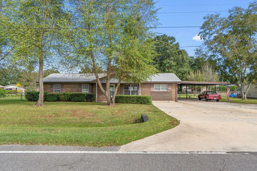 Spacious 4 bedroom 3 bath brick home with two primary suites. Home is situated on a large corner lot and has a detached workshop/shed and a double carport. Home has a large family room with laminate wood flooring and built in shelving. Kitchen has tile floors, pantry and overlooks the backyard. Breakfast/dining area. Family room is off the kitchen and opens to the covered back patio. The perfect place for backyard living and BBQ's. One primary suites has lots of natural light and two walk in closets. The second primary bedroom is on the opposite side of the home and would be great as a mother in law suite. The 3rd bedroom is a great size and 4th bedroom has been used as an office with lots of shelving. Spacious laundry room with lots of room for storage and a utility sink. Backyard is ful